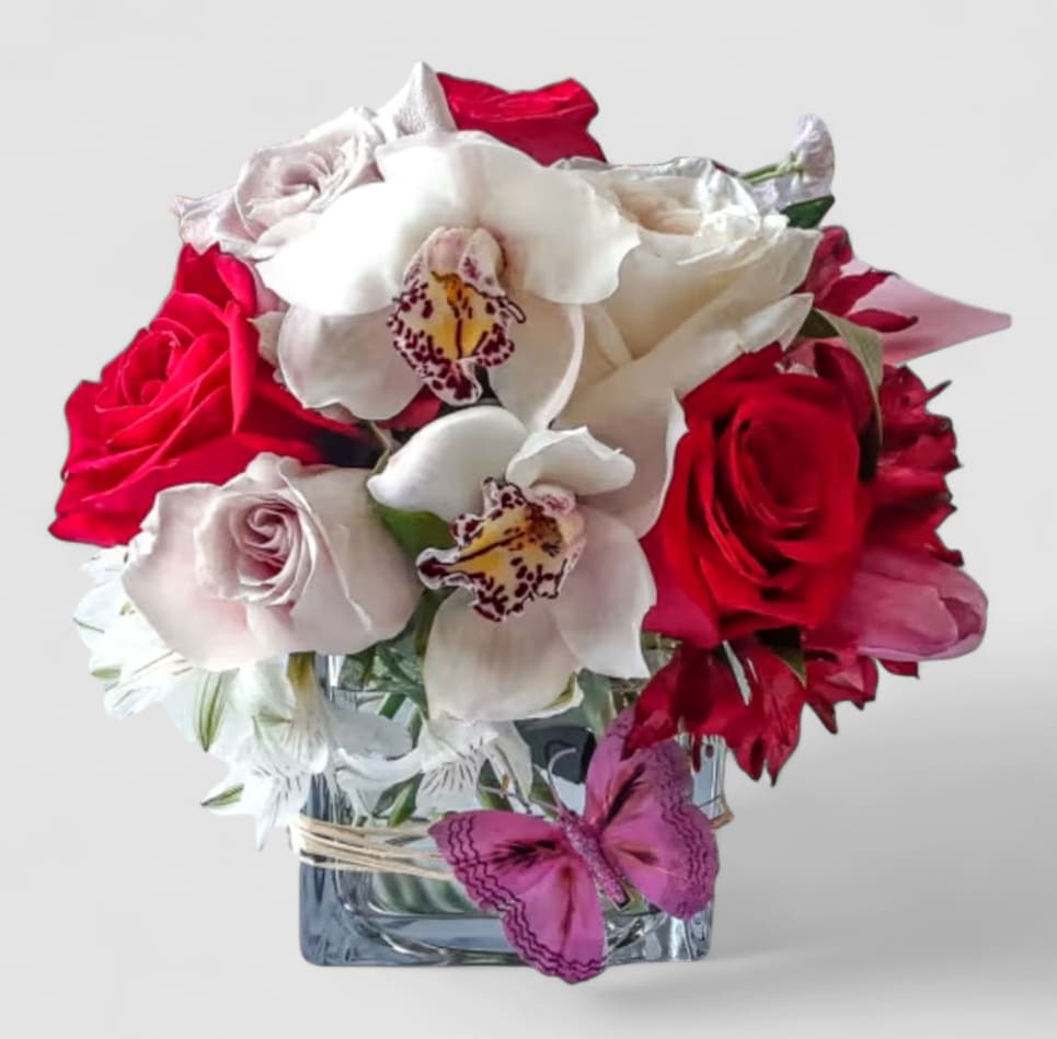 Love Ya Bouquet Designer's Choice - Red and white blossom selection of that day roses orchids and more arranged in a modern glass cube vase. Perfect for every occasion. Send this beautiful bouquet today to show them how much you love them. All fresh flower designs that leave my flower studio shop are beautiful works of art, made special each and every time. Send them your love! Send them a special bouquet to make them smile.