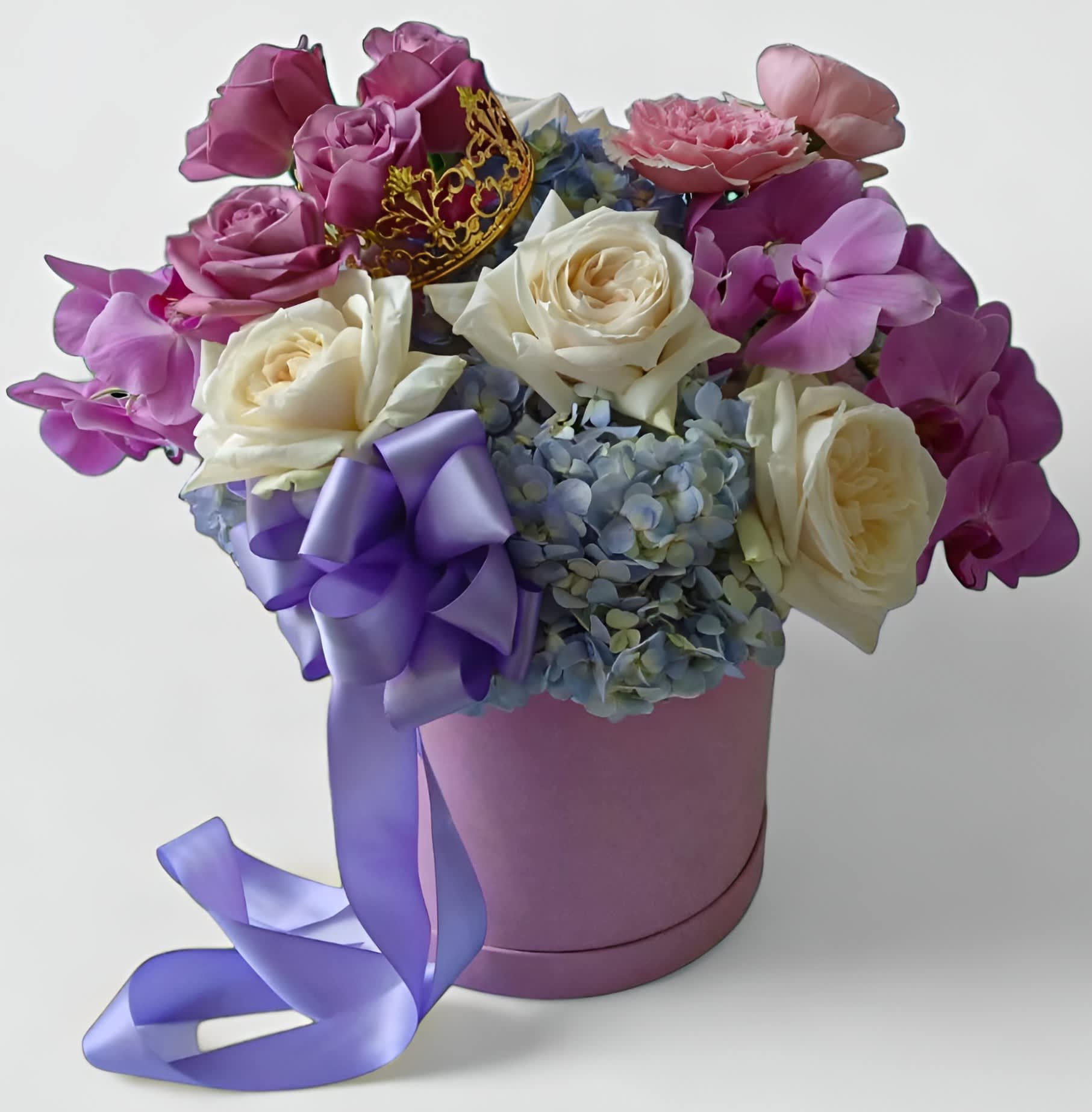 Lavender Blue Vanilla Flower Box - Roses orchids and more arranged in a beautiful lavender velvet hat box adorned with a gorgeous gold crown and long lavender satin flowing ribbons. Absolutely beautiful and perfect to send today for every occasion to show them how much you care. All of my bouquets are always made unique and extra special each and every time. Please visit my beautiful gallery to see what I have created for my latest customers. Updated daily. Send them happiness today. 