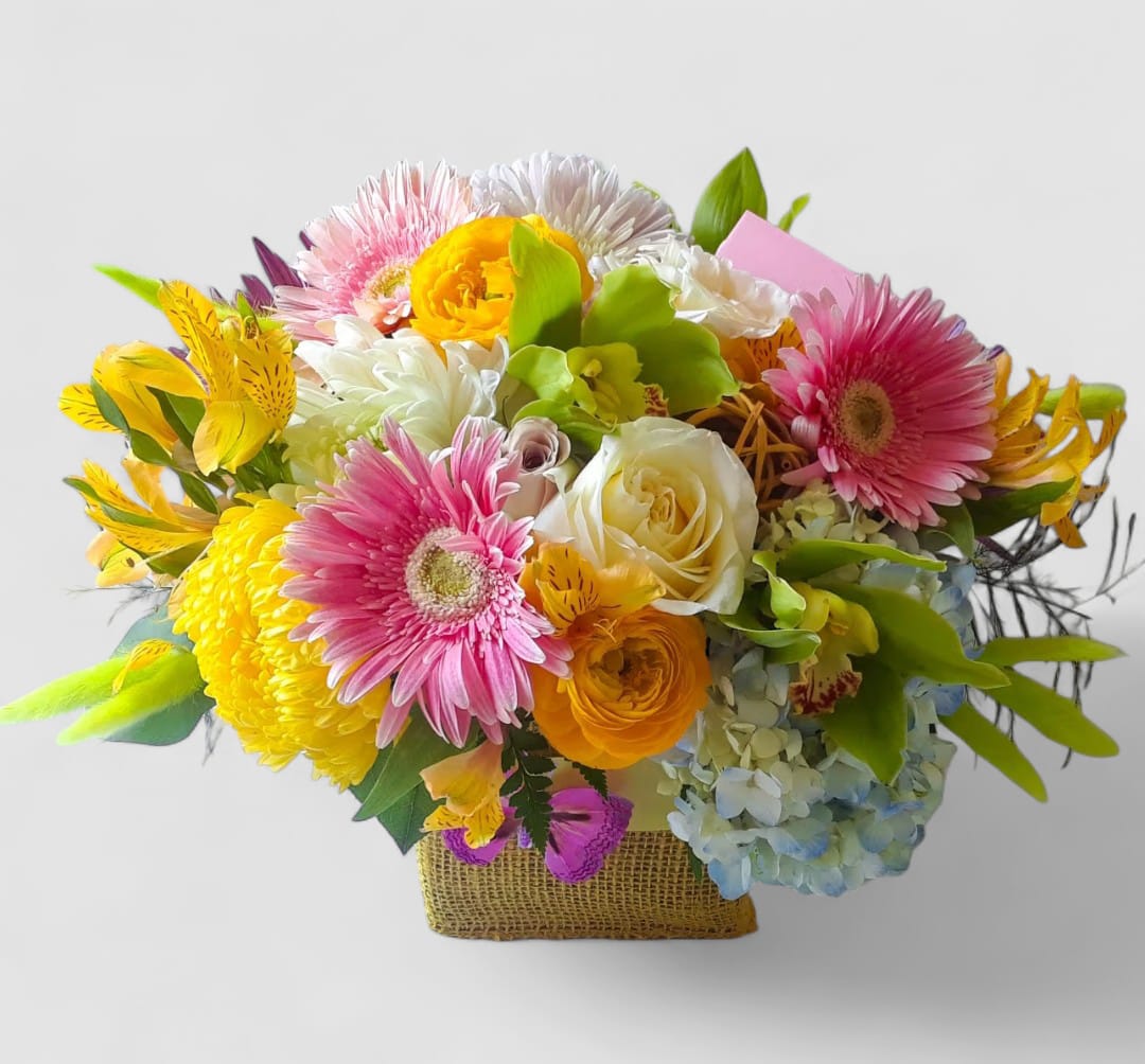 Happy Birthday Blossom Bouquet Designer's Choice - Roses orchids and more arranged in a modern glass cube style vase wrapped in pretty yellow jute ribbon. Beautiful and perfect to send today to show them how much you care. All of my bouquets are always made extra special and unique each and every time. Send them happiness.