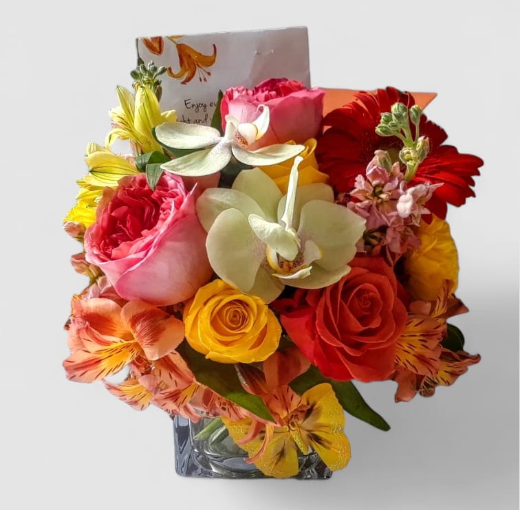 Peach And Yellow Bouquet Designer's Choice - Roses orchids and more arranged in a modern glass cube vase. Perfect to send today to show them how much you care. Always made unique and extra special each time. Send happiness.