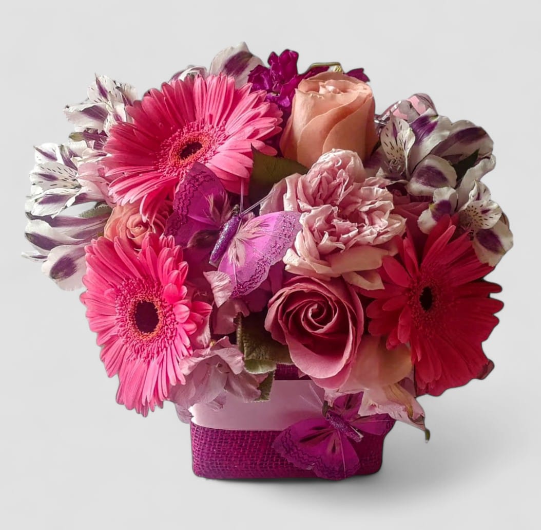 Sending Hugs Bouquet Designer's Choice - Beautiful and filled with pink and white roses orchids and more arranged in a modern glass vase wrapped in pretty pink jute ribbon. Perfect to send today to make their day. Always made extra special and unique each time. Send happiness.