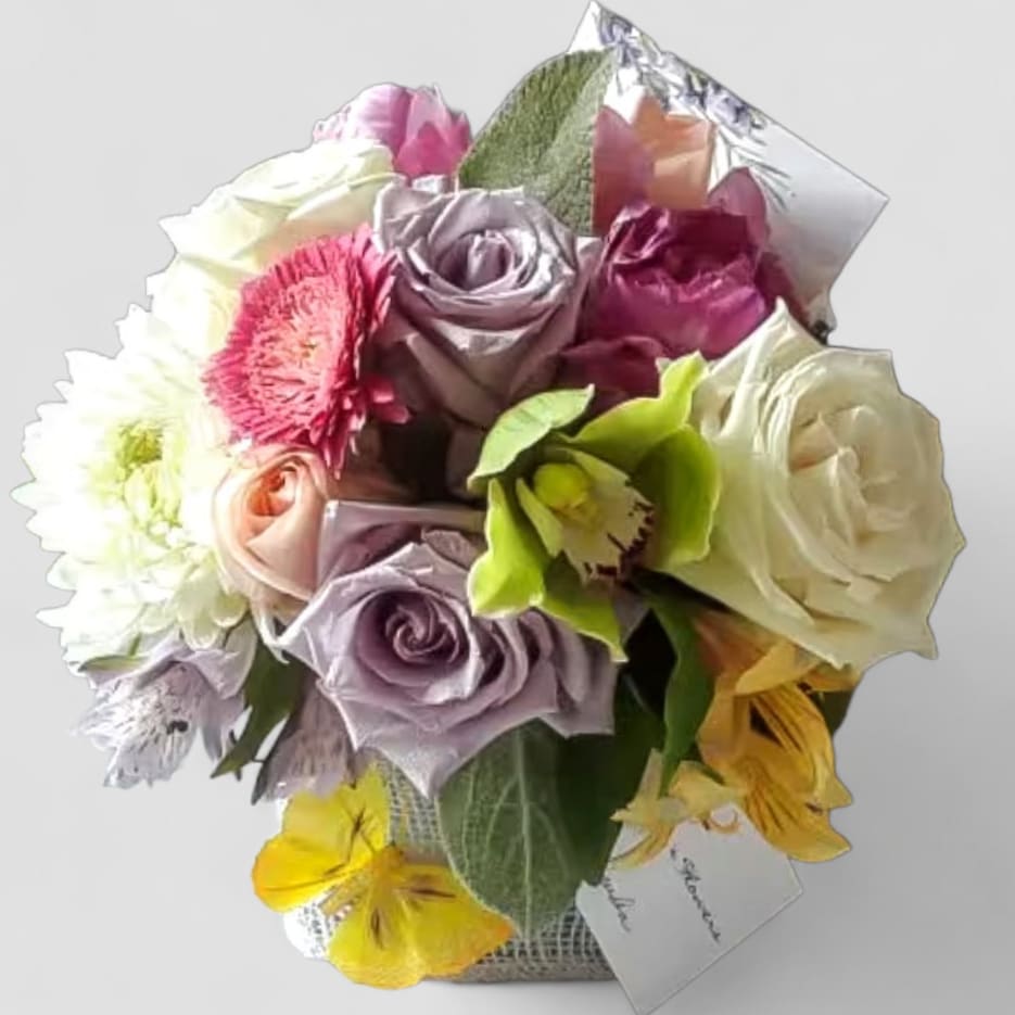 Sending Healing Vibes Pastel Bouquet Designer's Choice - Send this beautiful pastel color bouquet filled with roses orchids and so much more arranged in a modern glass cube vase wrapped in vanilla jute ribbon. Perfect to send for every occasion or reason. All fresh bouquets are made unique and special each and every time. Send them well wishes for a speedy recovery. 