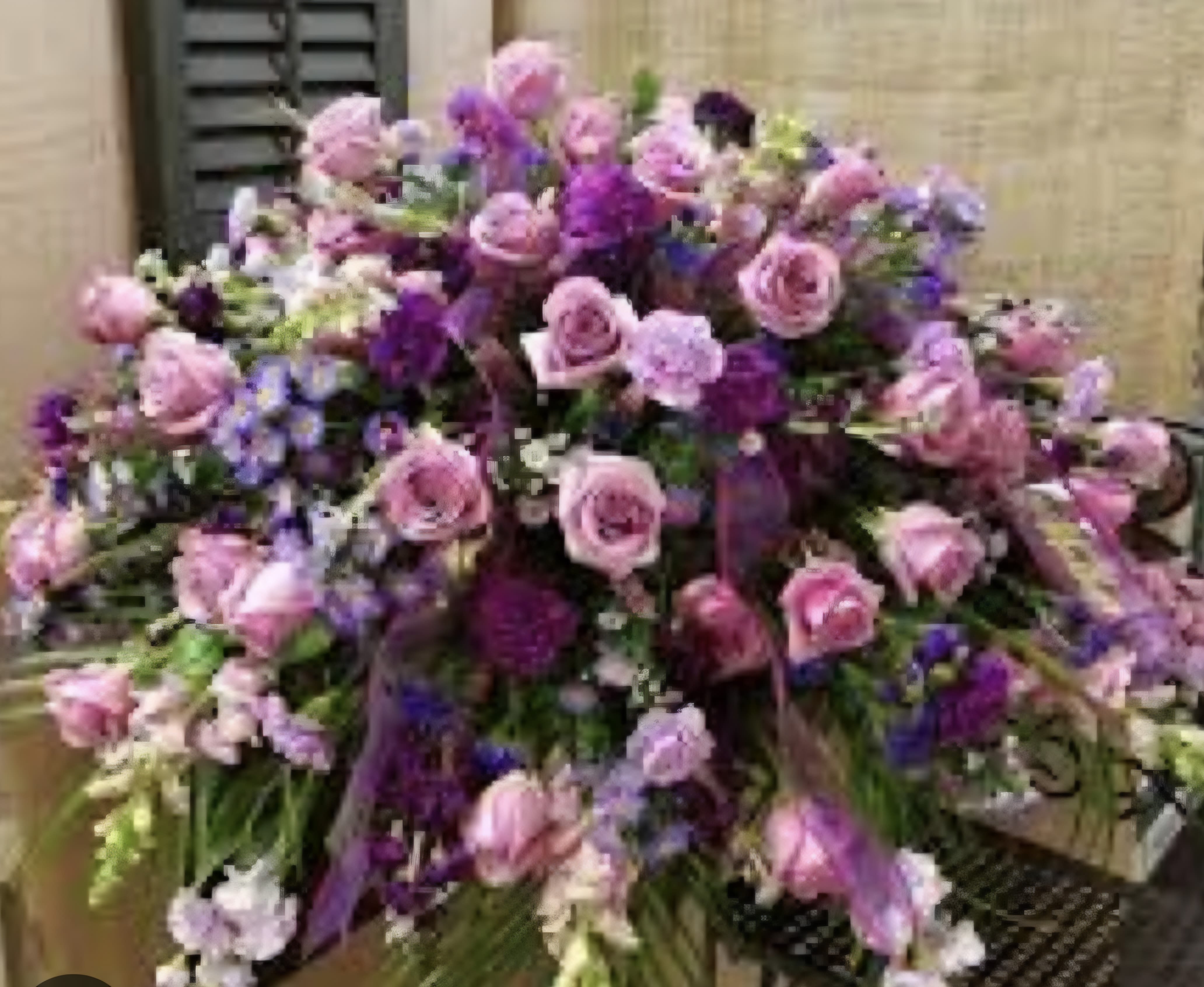 Pop of Purple - This shades of purple casket spray is a rich addition to any casket. 