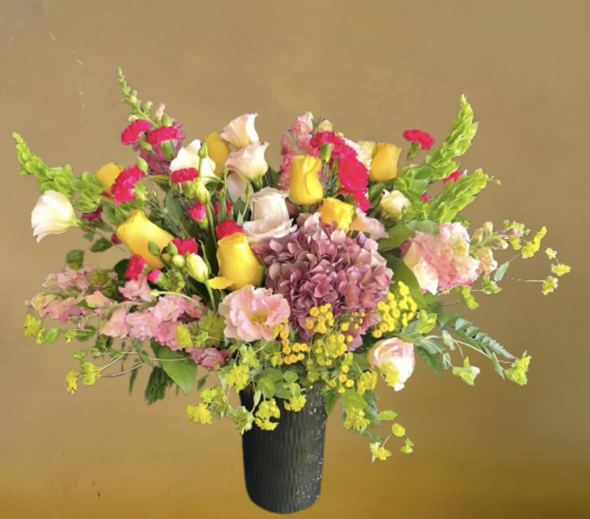 Vibrant Garden by D'Lily's Flowers Vibrant Garden by D'Lily's Flowers - This stunning mix of flowers goes out of its way to show appreciation towards any friend, lover or family member. Bring a smile with these beautiful flowers! DISCLAIMER: Flowers may be substituted if needed to.