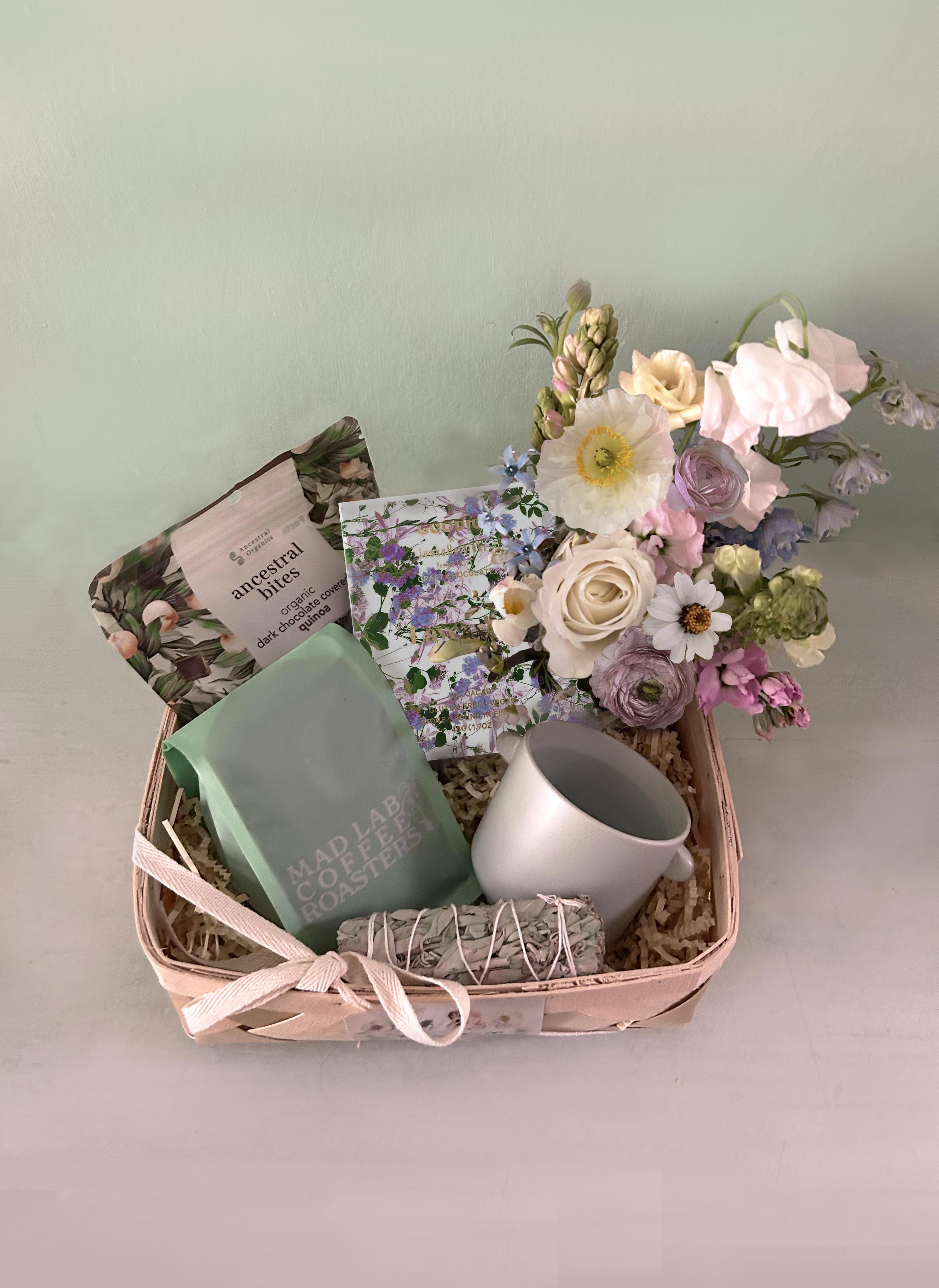 Dolly Basket Dolly Basket - The tasteful and LA famous coffee "Dolly" from Mad Lab Coffee in La is the namesake for this gorgeous basket full of fresh flowers, coffe & chocolate. LA made Mad Lab "Dolly" coffee Organic Dark Chocolate Covered Quinoa, sustainably grown Goodio lavender fields forever - premium craft chocolate topped with fragrant lavender crystals. Vegan - gluten-free Light turquoise coffee cup Sage smudge stick Blomst arrangement in a mini clear vase. Placed in a natural wood basket. Available for LA hand delivery. Looking to ship a gift box out of state, go to our sister site: www.blomstlosangeles.com