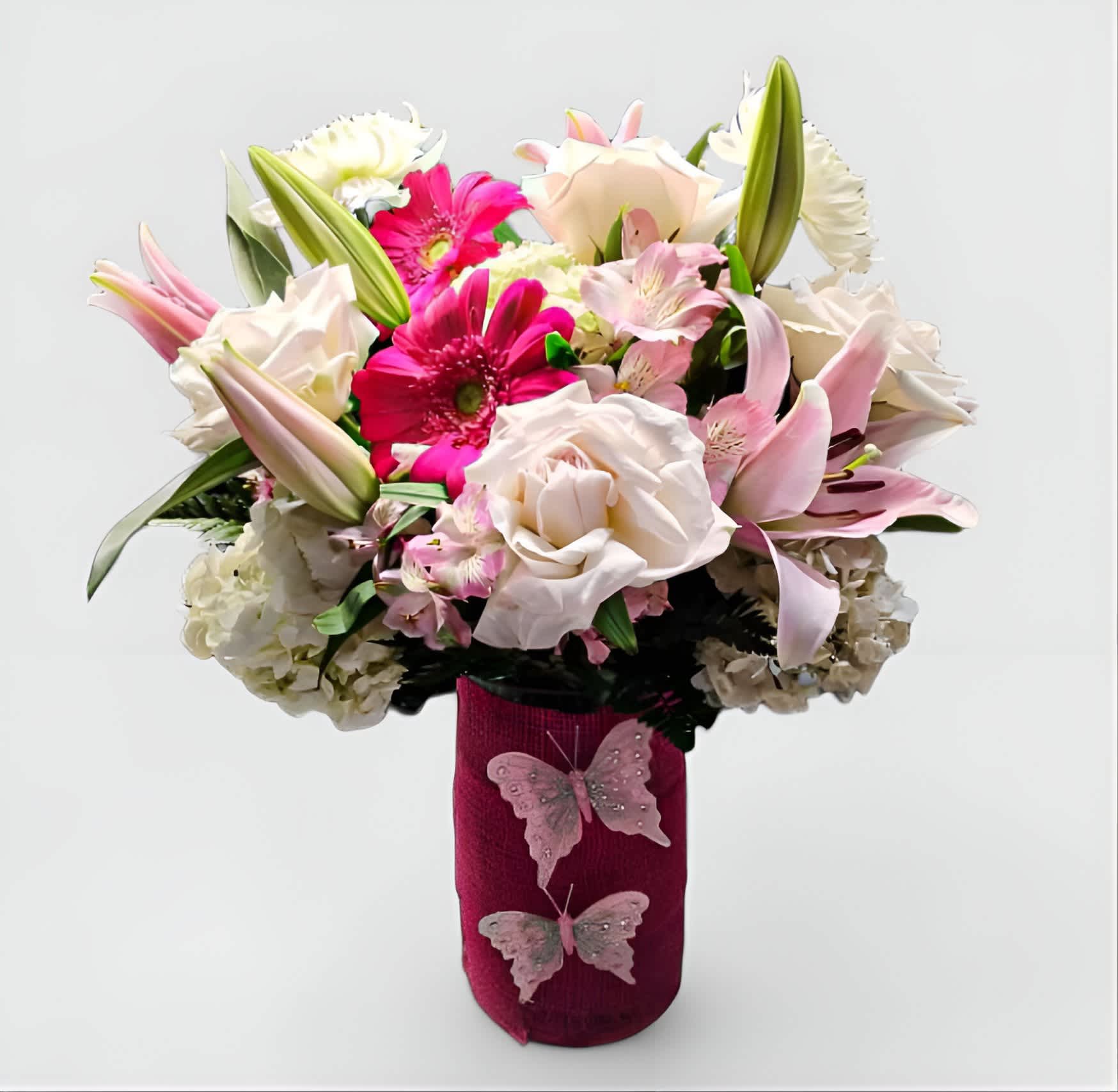 Pink Vanilla Bouquet Pink Vanilla Bouquet - Designer's choice; made beautifully from my pink and vanilla blossoms of the day roses orchids hydrangeas and lilies arranged in a tall modern glass cylinder vase wrapped in pretty pink jute ribbon adorned with a sparkly butterfly. Beautiful and perfect to send today to make them smile. All of my bouquets are always made extra special and unique each time. Send happiness.