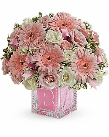 Baby's First Block - Pink - Celebrate the cutest baby girl on the block's arrival with this charming glass baby block that arrives chock full of pretty flowers. Perfect for baby showers, too! The glass block will make an adorable display piece for years! Pretty light pink and white spray roses, waxflower and pink satin ribbon are delivered in a clear baby block with a pink liner. One amazing delivery deserves another, don't you think?