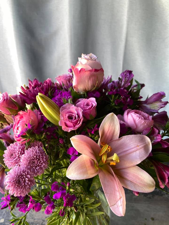  Every Day Passion -  Fresh picked flowers in a ray of purple and lavenders , with fresh greens arranged in a clear  9&quot; gathering Vase