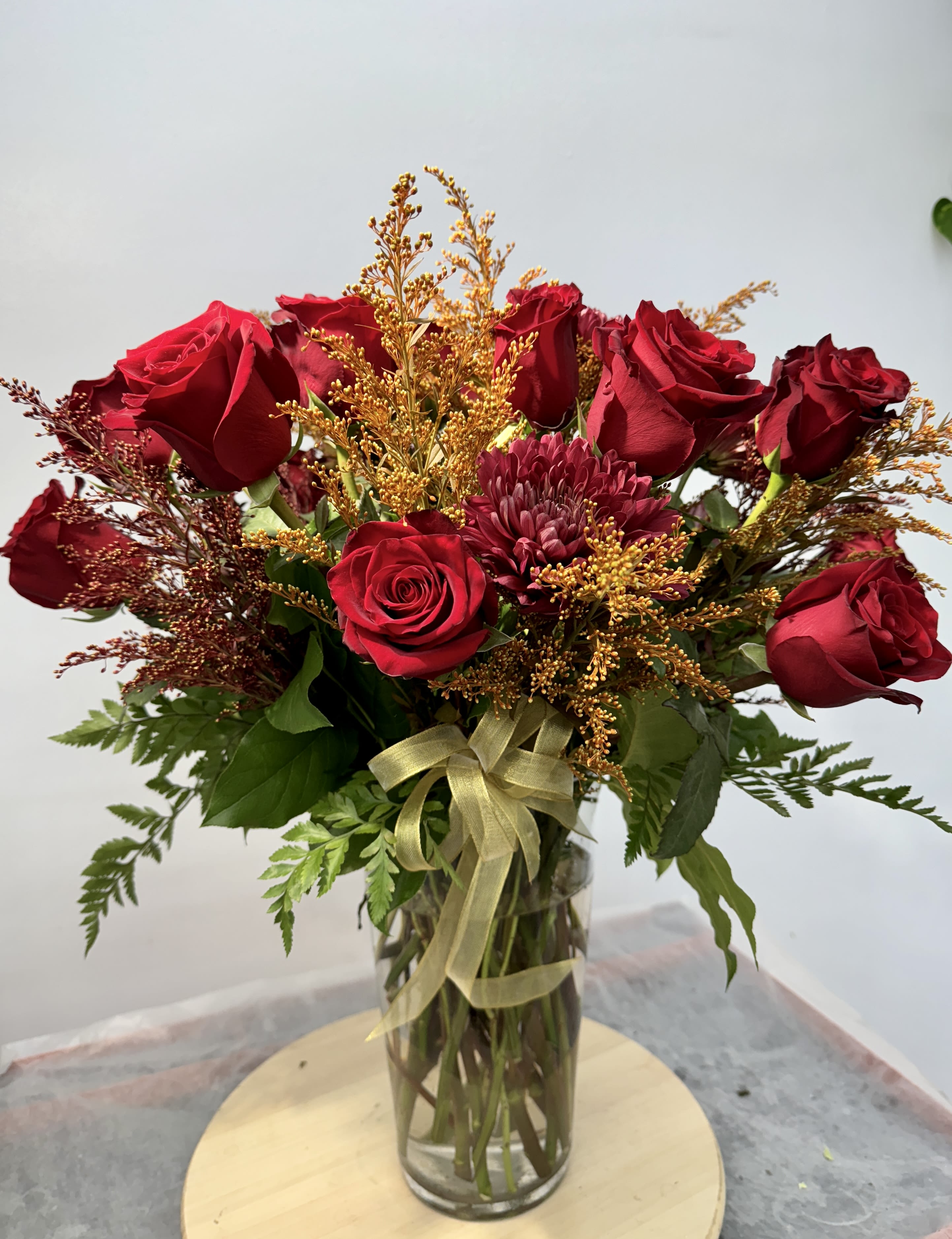 Red Autumn  - This vase of brilliant red roses is an elegant and natural way to say, &quot;I love you.&quot; Truly a classic for a reason 1 dozen and 1/2 half roses  Solidago  Moms Vases