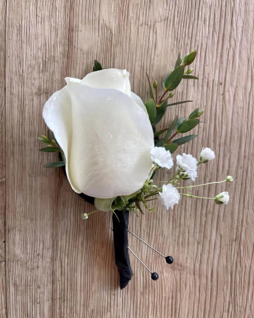 Boutonniere - Weather you prefer a classic rose, a rustic spring of greenery or a seasonal floral accent, our boutonnieres bring polish, charm and personal touch to match your style and colors!
