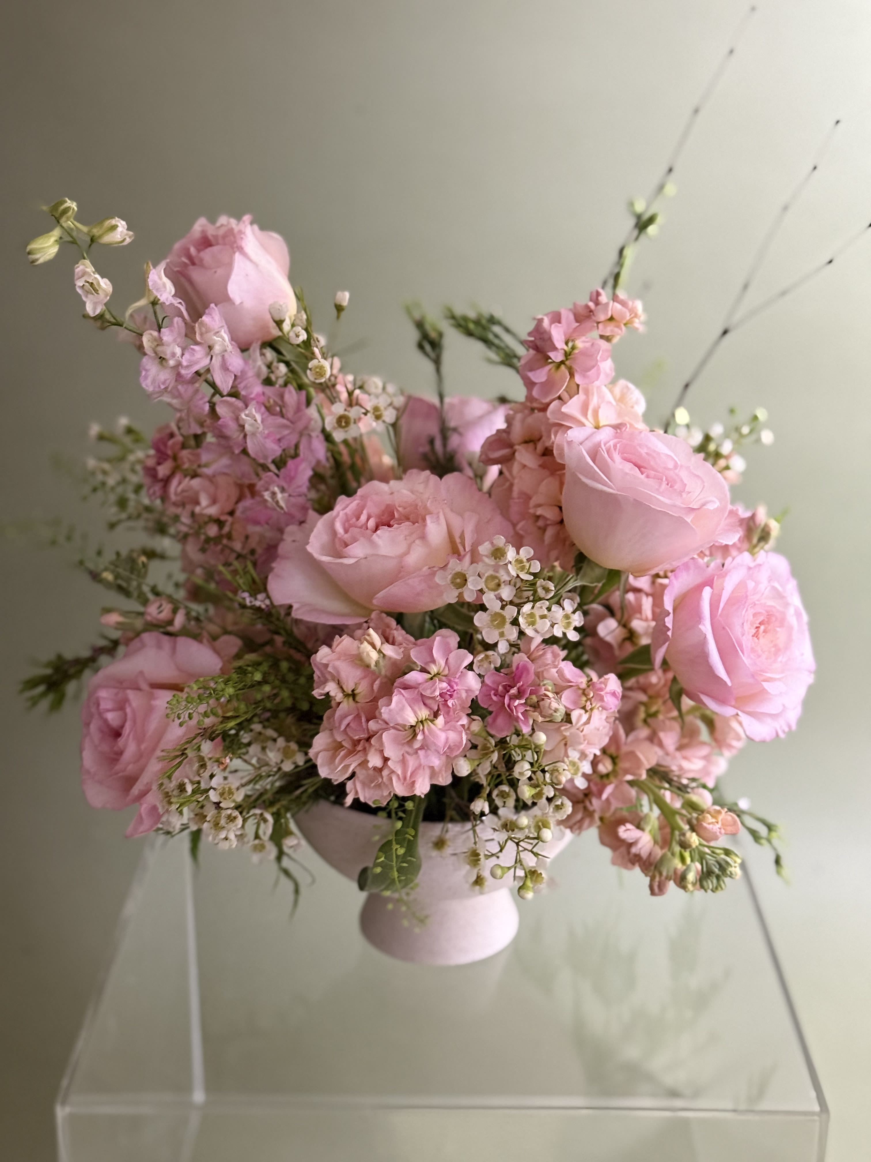 Designer's Choice Luxurious Compote - Premium Compote Arrangement - Elegant, artful, unforgettable.    This luxe floral design is arranged in a beautiful compote vessel, overflowing with premium blooms and lush textures. Each piece is artfully composed for movement, balance and romance - perfect for making a grand statement. Designed with the season's most exquisite flowers, your arrangement will be created just for you, ensuring it's as unique as it is breathtaking. *Photos shown are examples only; each design is one of a kind. 