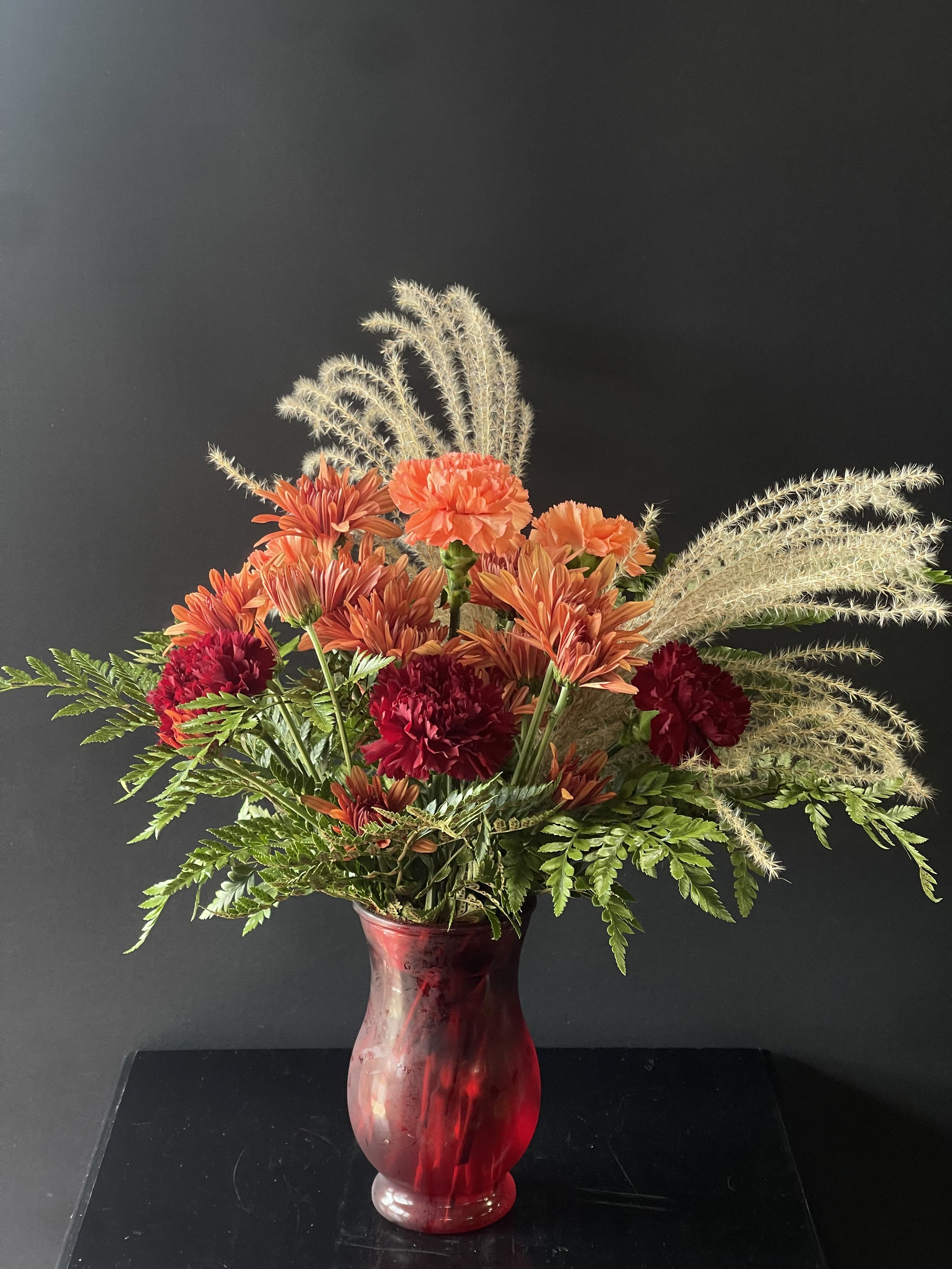 A Fall Favorite - A fall inspired arrangement with carnations, cushion sprays, and pampas grass.