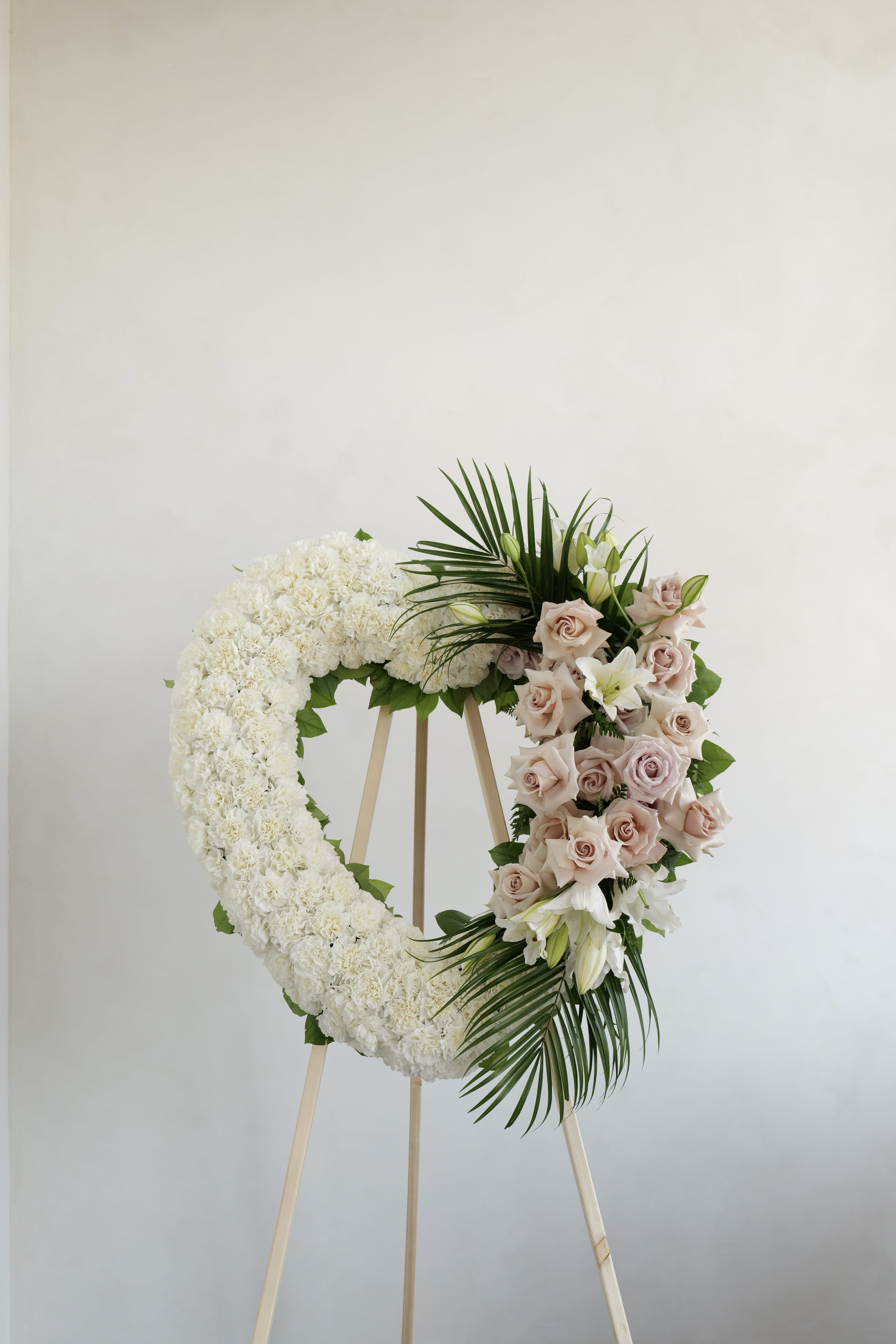 Wreath No. 04 - A heart wreath thoughtfully designed with fresh blooms to convey peace, love, and remembrance. A timeless tribute to honor and celebrate the memory of a loved one with elegance and grace.  27&quot;