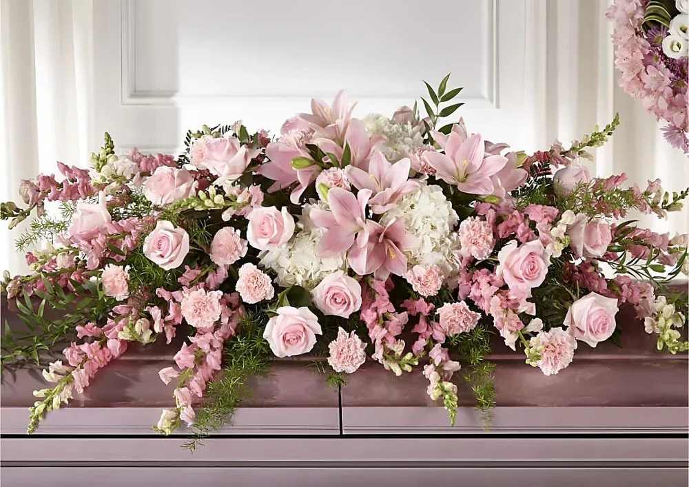 Casket Spray Elegant Rose - This casket spray is arranged with care to honor your loved one's memory. A gentle selection of blooms offers a sincere expression of sympathy. Placed on the casket, it conveys a message of respect and remembrance.