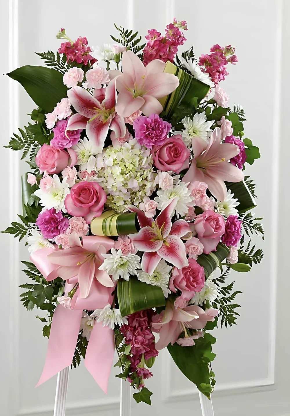 Easel Spray Rose Deluxe Easel Spray Rose Deluxe - This easel spray stands as a quiet tribute to a life well-lived. Soft blooms and greenery bring a sense of comfort to the service. Placed near the casket, it serves as a gentle reminder of love and support.