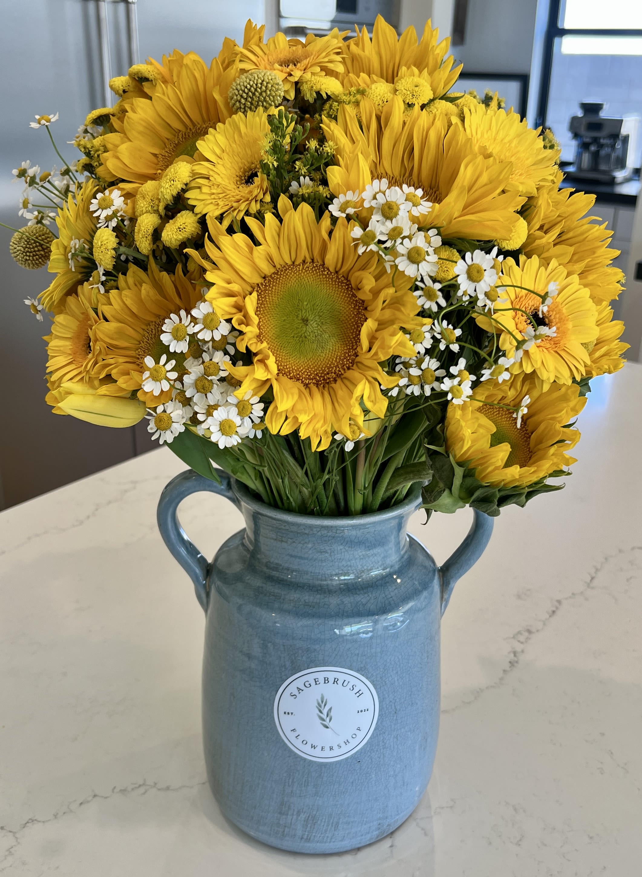 Happiness Happiness - A mix of sunflowers and other yellow and white flowers/greenery in a nice vase.