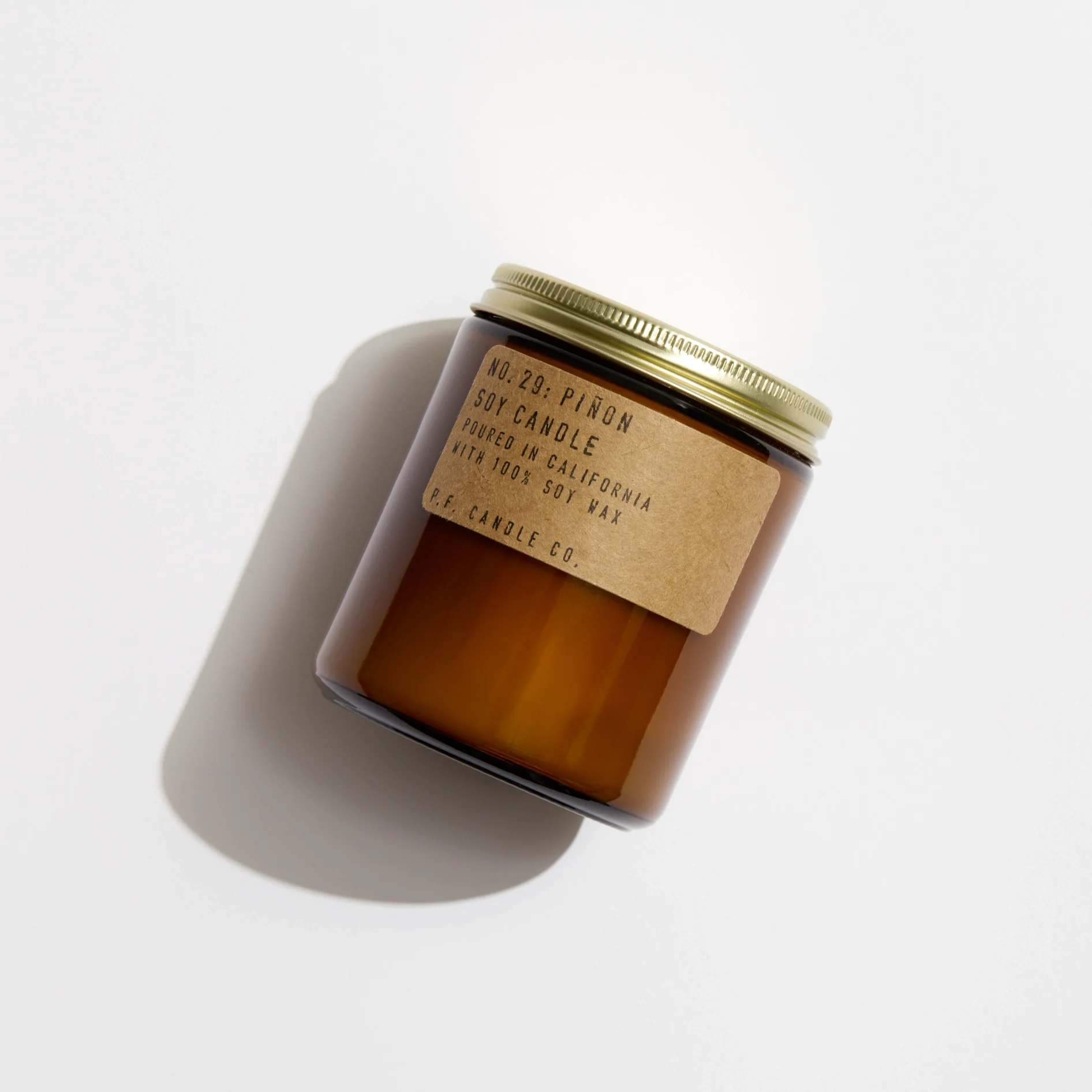 Piñon - 7.2 oz Standard Soy Candle - Description  Winters in the Southwest, lingering bonfires, wool jackets in rotation. Notes of piñon logs, cedar, and vanilla.  This is our most popular size and is meant for dressers, countertops, nightstands – basically everywhere.   Our 7.2 oz Standard Candles are hand-poured into apothecary inspired amber jars with our signature kraft label and a brass lid.   Our candles are simple - they're all made with 100% domestically grown soy wax, fine fragrance oils, and cotton-core wicks. The fragrances we use are paraben-free, phthalate-free, and never (ever) tested on animals.  Burns for 40-50 hours.  Your customers might also like creamy Patchouli Sweetgrass.  Details  SKU: SC29 Made in United States Benefit: Relaxing Burn Time: 40-50 hours Flame Type: Flame