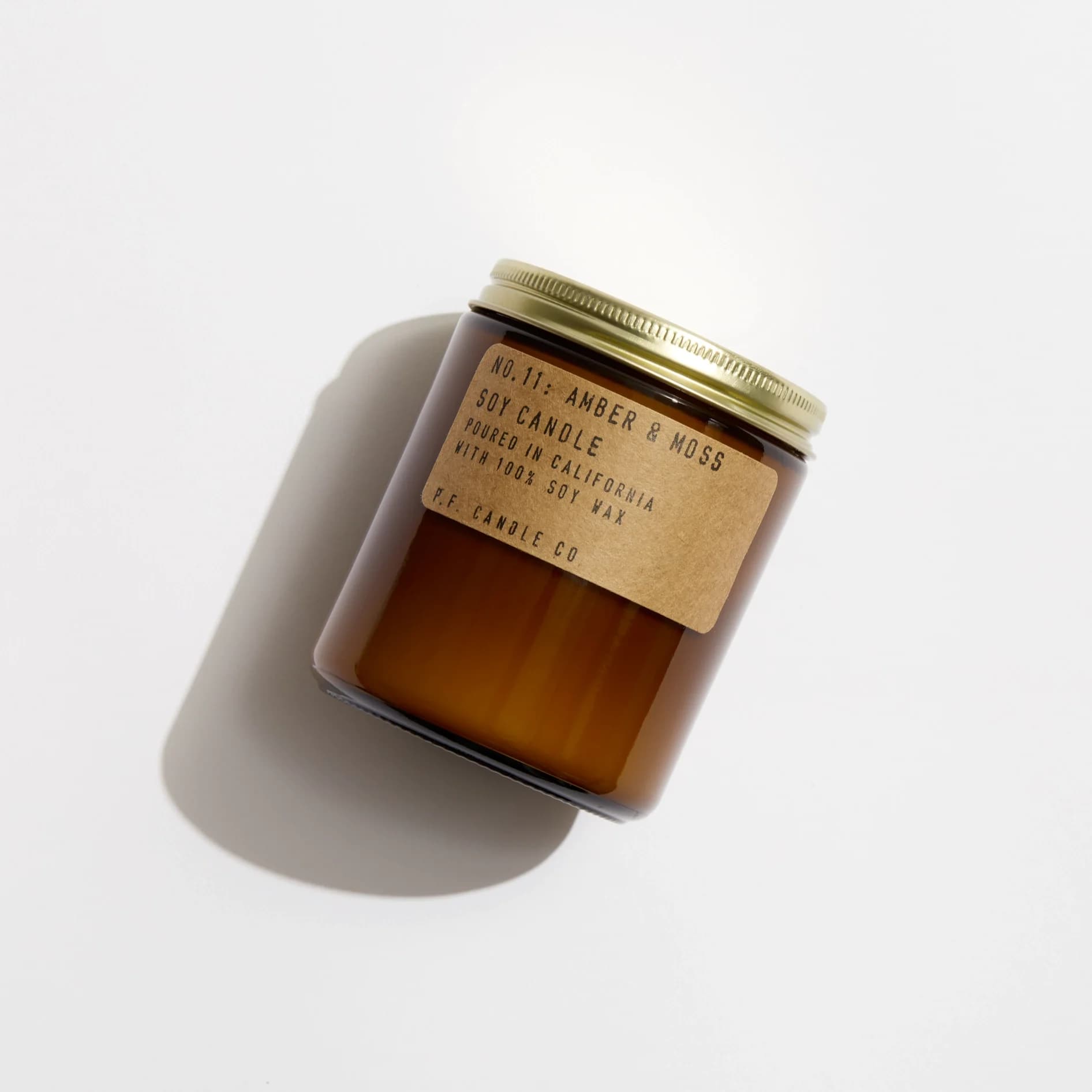 Amber &amp; Moss - 7.2 oz Standard Soy Candle - Description  A weekend in the mountains, sun gleaming through the canopy. Notes of sage, moss, and lavender.  This is our most popular size and is meant for dressers, countertops, nightstands – basically everywhere.   Our 7.2 oz Standard Candles are hand-poured into apothecary inspired amber jars with our signature kraft label and a brass lid.   Our candles are simple - they're all made with 100% domestically grown soy wax, fine fragrance oils, and cotton-core wicks. The fragrances we use are paraben-free, phthalate-free, and never (ever) tested on animals.  Burns for 40-50 hours.  Your customers might also like bright Bergamot Shiso or fresh Ojai Lavender.  Details  SKU: SC11 Made in United States Benefit: Relaxing Burn Time: 40-50 hours Color: Brown