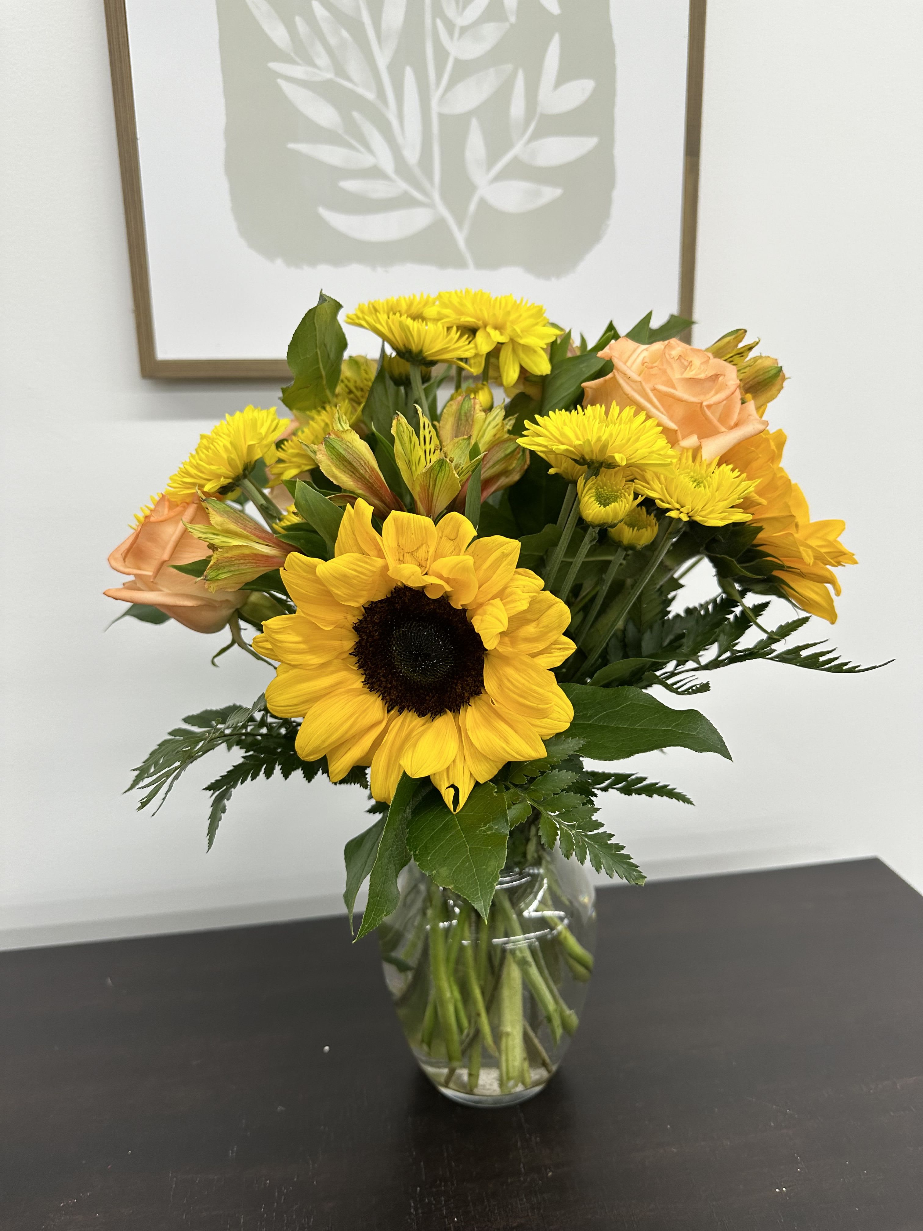 Honey Bee -  Simple but stunning bouquet for any occasions. An arrangement with Sunflowers, roses, daisies, and Alstroemeria are sure to brighten anyones day.  