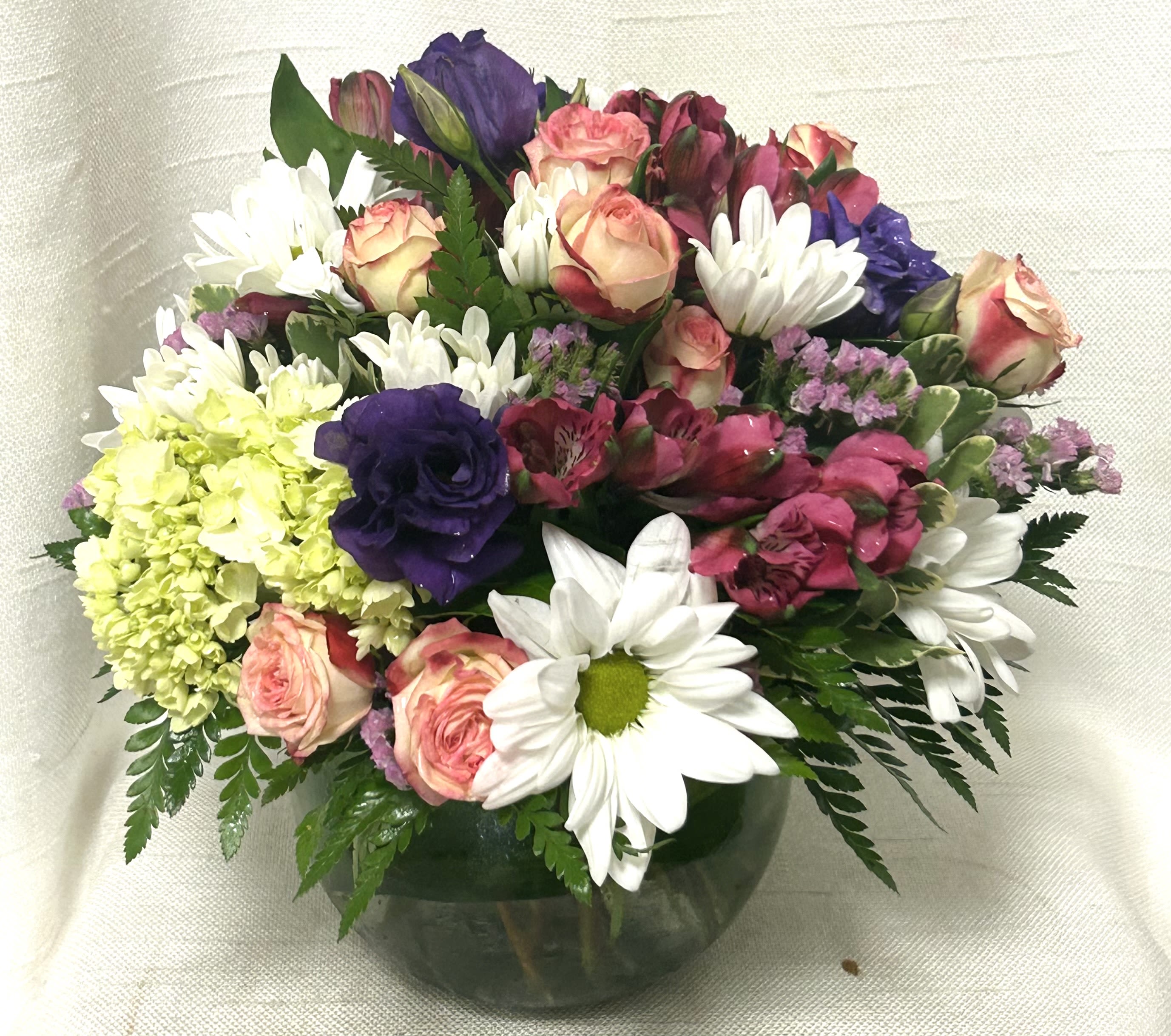 Timeless Simplicity (BB) - Introducing the &quot;Timeless Simplicity&quot; Flower Arrangement, a delightful mix of daisies, spray roses, green trick, hydrangeas, and mini carnations arranged in a beautiful wooden box. The &quot;Simple Charm&quot; arrangement exudes simplicity, elegance, and natural beauty, making it a perfect choice for those seeking a minimalist yet charming bouquet.