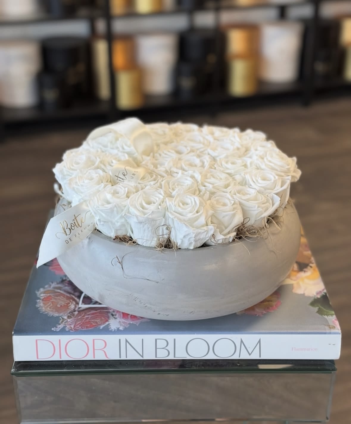 Eternal Love - Around 2 dozen white preserved forever roses nestled in a concrete vase.