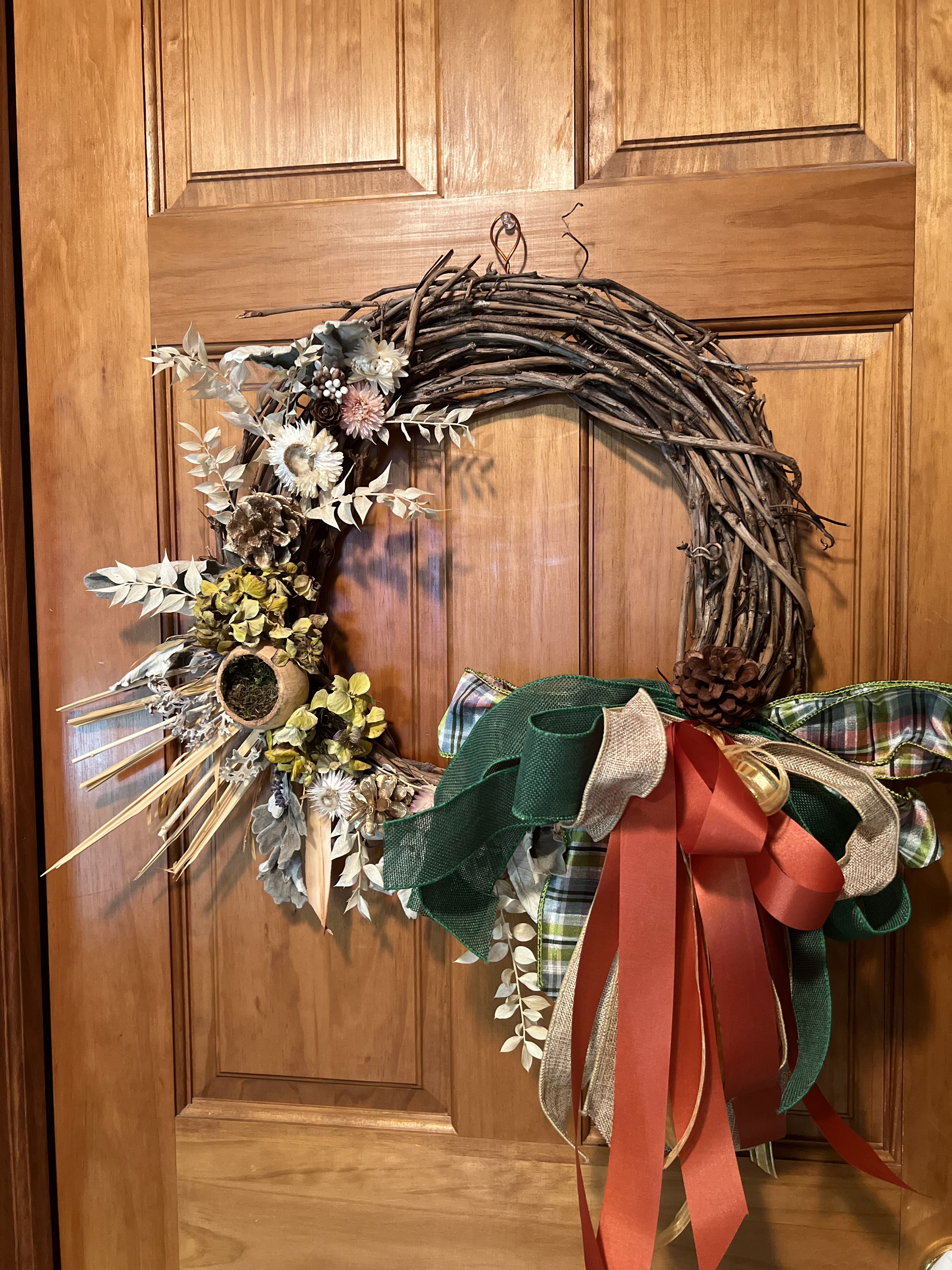 Perserved Wreath - A gorgeously preserved wreath with bleached ruscus, palm leaves, pinecones, preserved dusty miller, hydrangea, strawflowers and a preserved pod. Best for indoor use. Hanger attached. Sure to become a keepsake. Hang and store out of direct light.