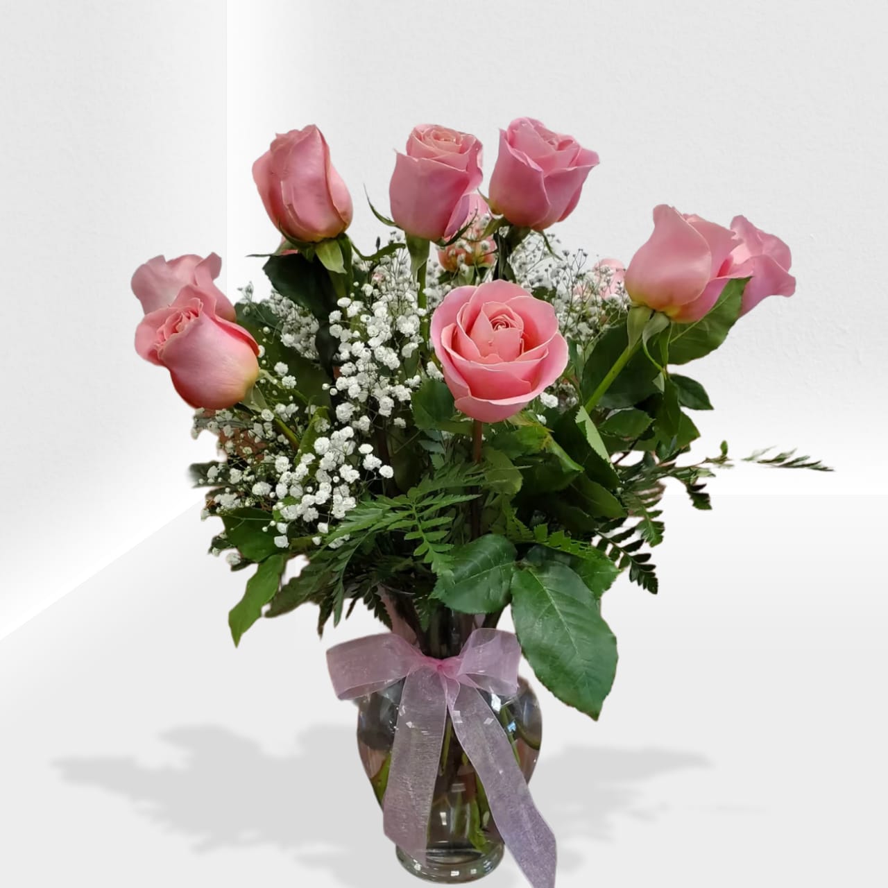 Dozen light pink roses - A beautiful way to show your love with a soft touch of pink. Standar size 12, deluxe 18 roses and premium 24 roses.