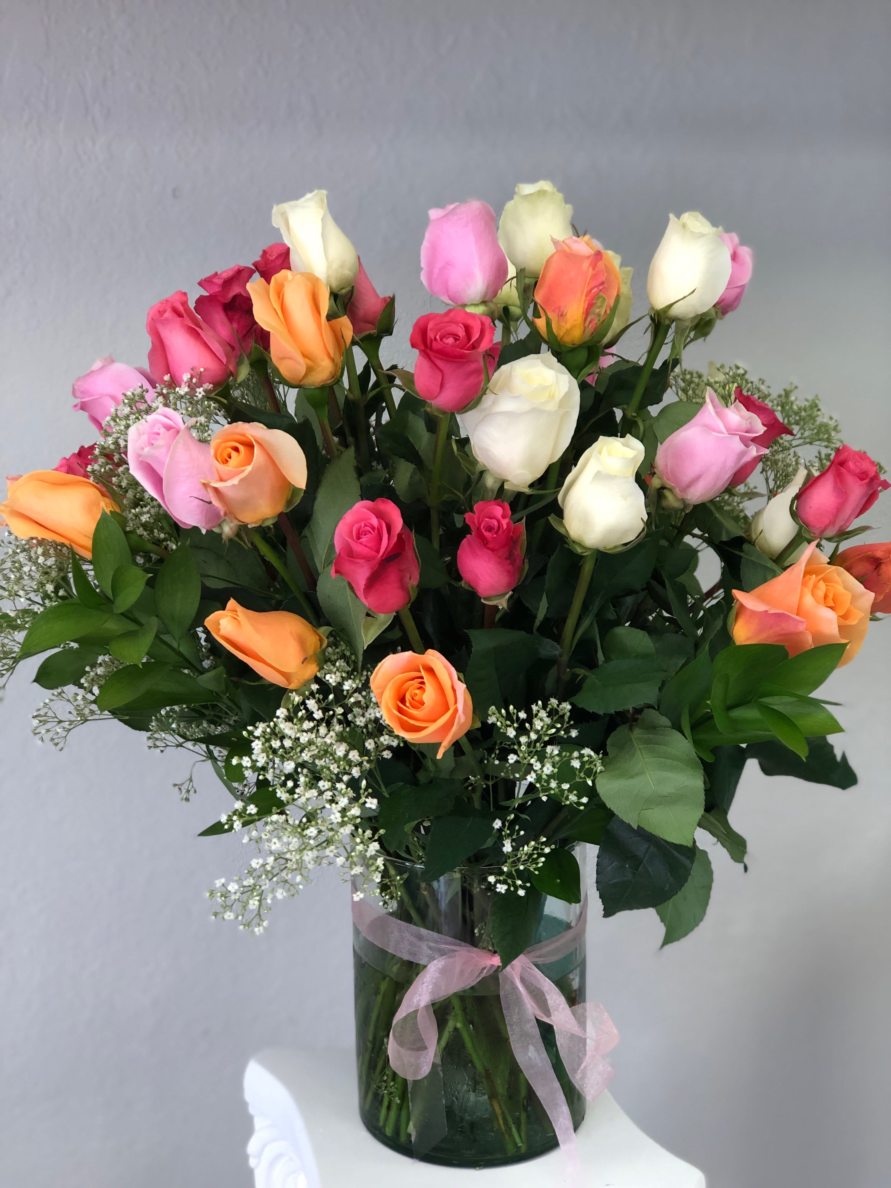 50 Colored Roses  - 50 vibrant colored roses in a vase with babies breath and greens