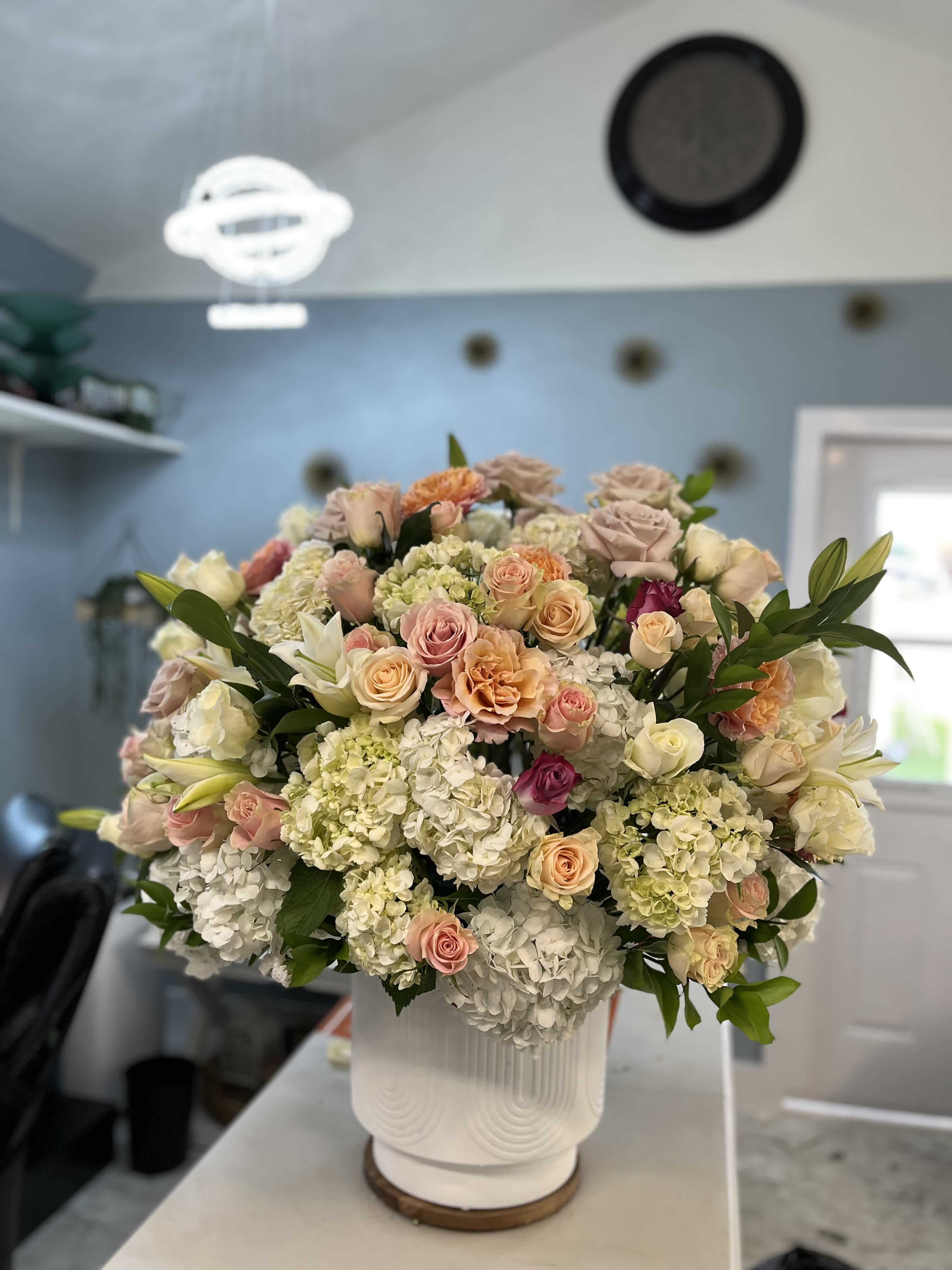 The breakers  - a 12&quot; white ceramic vase with 150 premium colored roses, white casa blanca Lillies 50 white hydrangea for a 3 foot arrangement. make sure your tables is sturdy enough for this 100 lb arrangement!