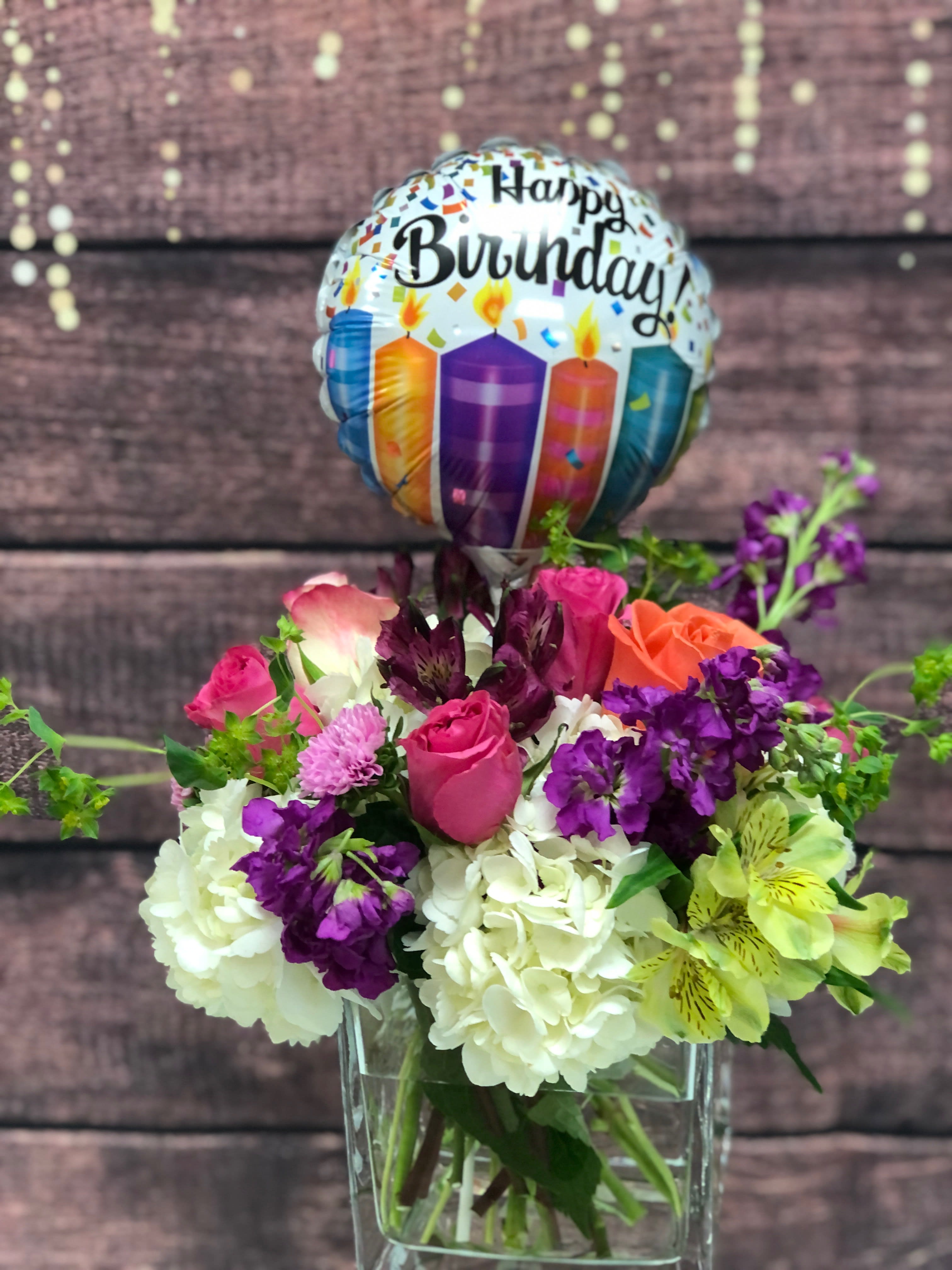 Birthday Party - A bright mix of assorted flowers tucked into hydrangea in a large square vase