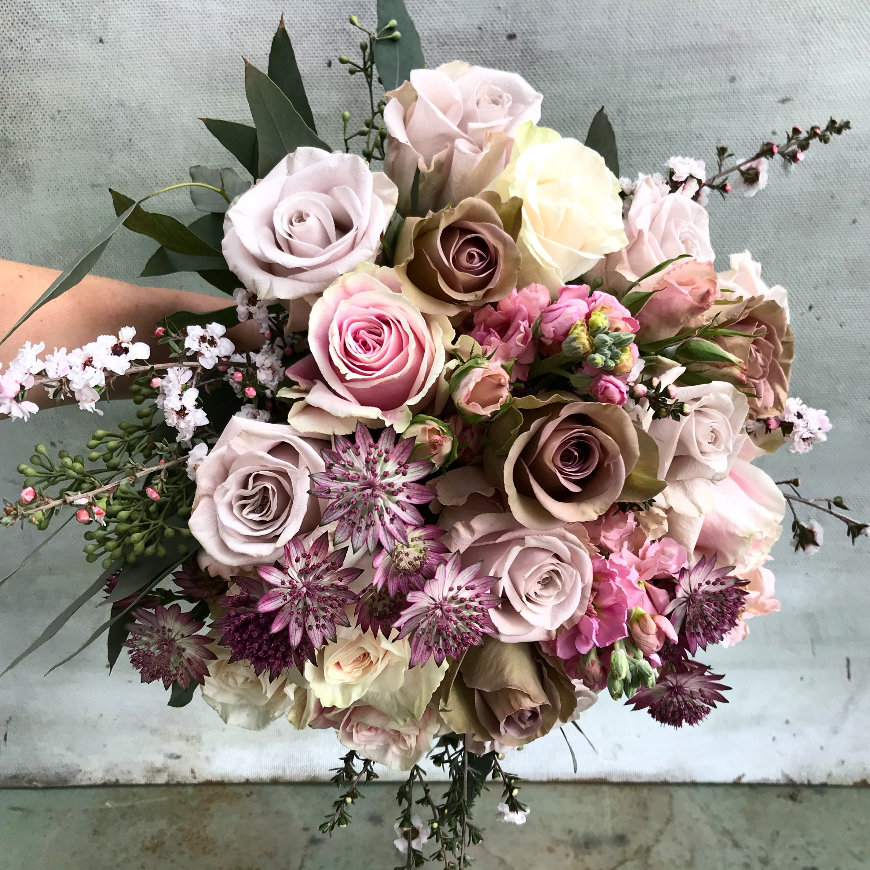 Mulholland bouquet - Make someone happy with the prettiest hand tied bouquet full of lovely powder and blush colors, the perfect fashionable fall palette. Roses of the prettiest nude colors mixed with blooming  wax flowers and other beautiful flowers. The bouquet is wrapped in silk paper and beautiful ribbon with pretty wrapping details. If you wish, you can add a vase to the order, and we will arrange  the bouquet beautifully in the clear cylinder vase. Choose Delyxe and Premium for more stems. Pictures are original. Blomst LA only uses fresh, high quality flowers, all carefully selected every day to fit your flower order. We offer a personal hand delivery by our own delivery staff and guarantee the flowers will look perfect, when they arrive. We deliver in Glendale, Pasadena, Eagle Rock, Hollywood, Burbank, Beverly Hills - and everywhere else in Greater Los Angeles.