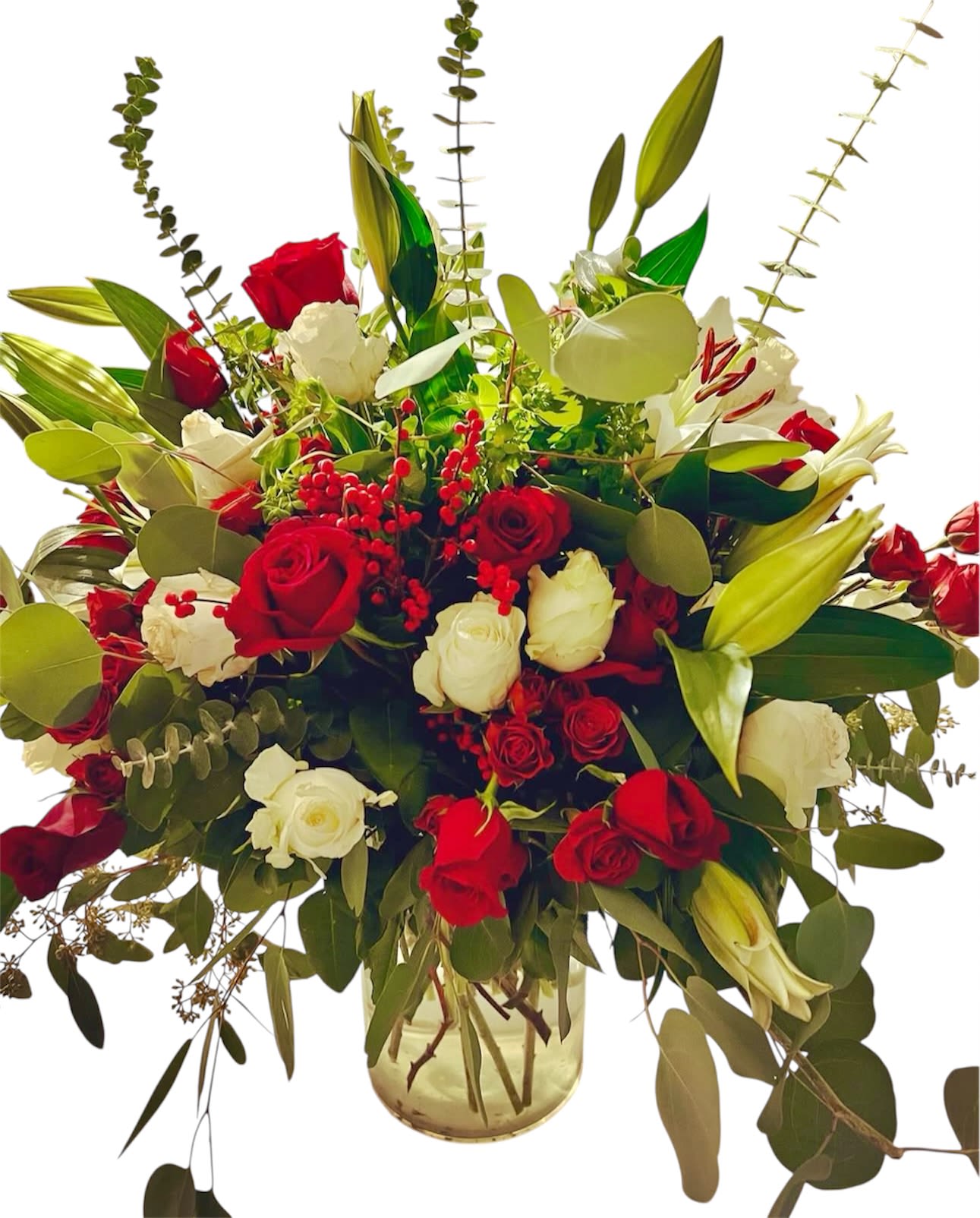 Festive Elegance - A stunning holiday bouquet featuring vibrant red and pure white roses, elegant white lilies, and an abundance of lush greenery, including eucalyptus. Unique round stems add texture and a festive touch, creating a bold and luxurious arrangement perfect for Christmas or any special occasion.