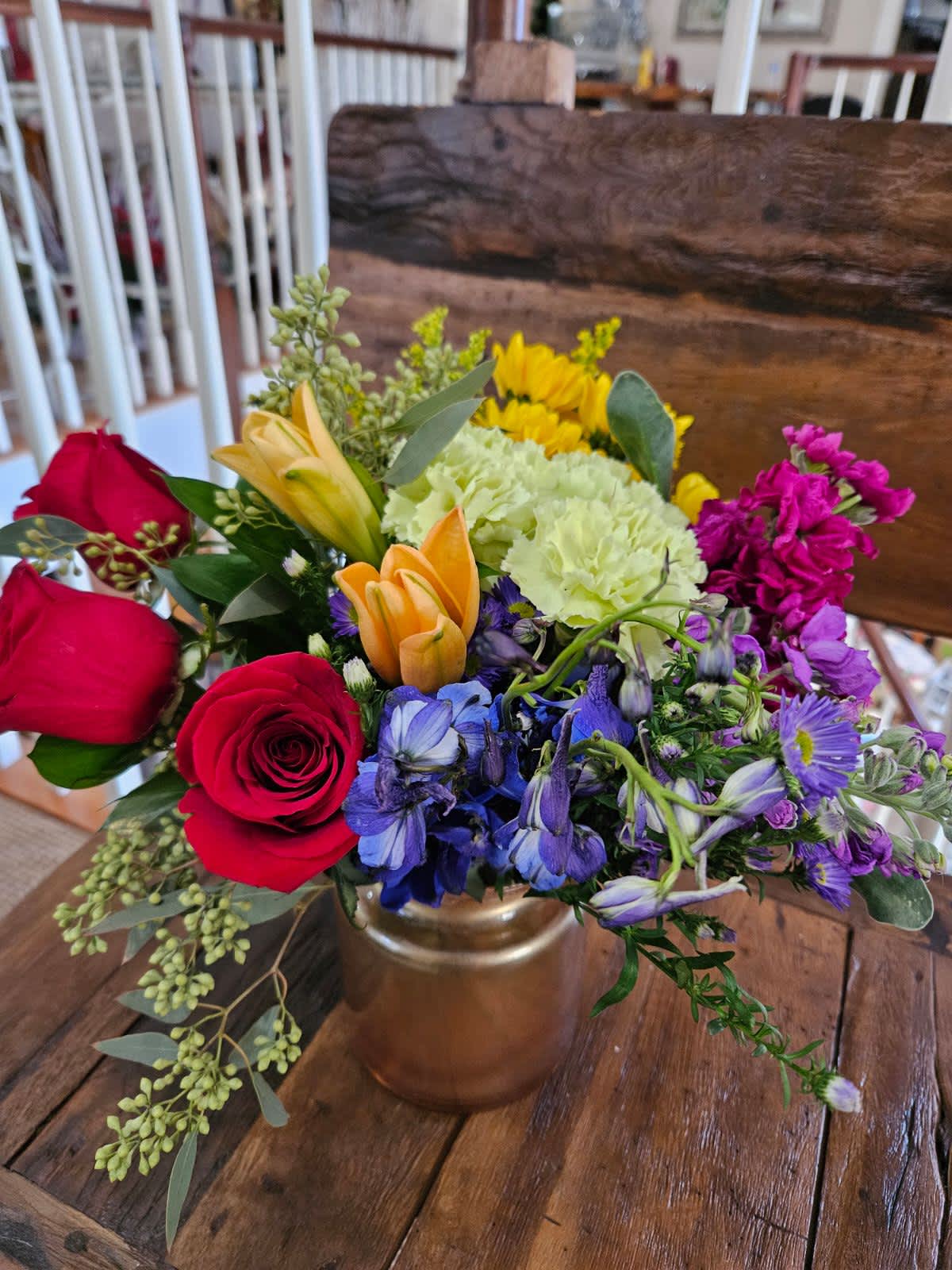 Pot of Gold Bouquet Pot of Gold Bouquet - All the colors of the rainbow designed in our popular milk jug style vase in gold. Your "Pot o' Gold" at the end of the Rainbow!