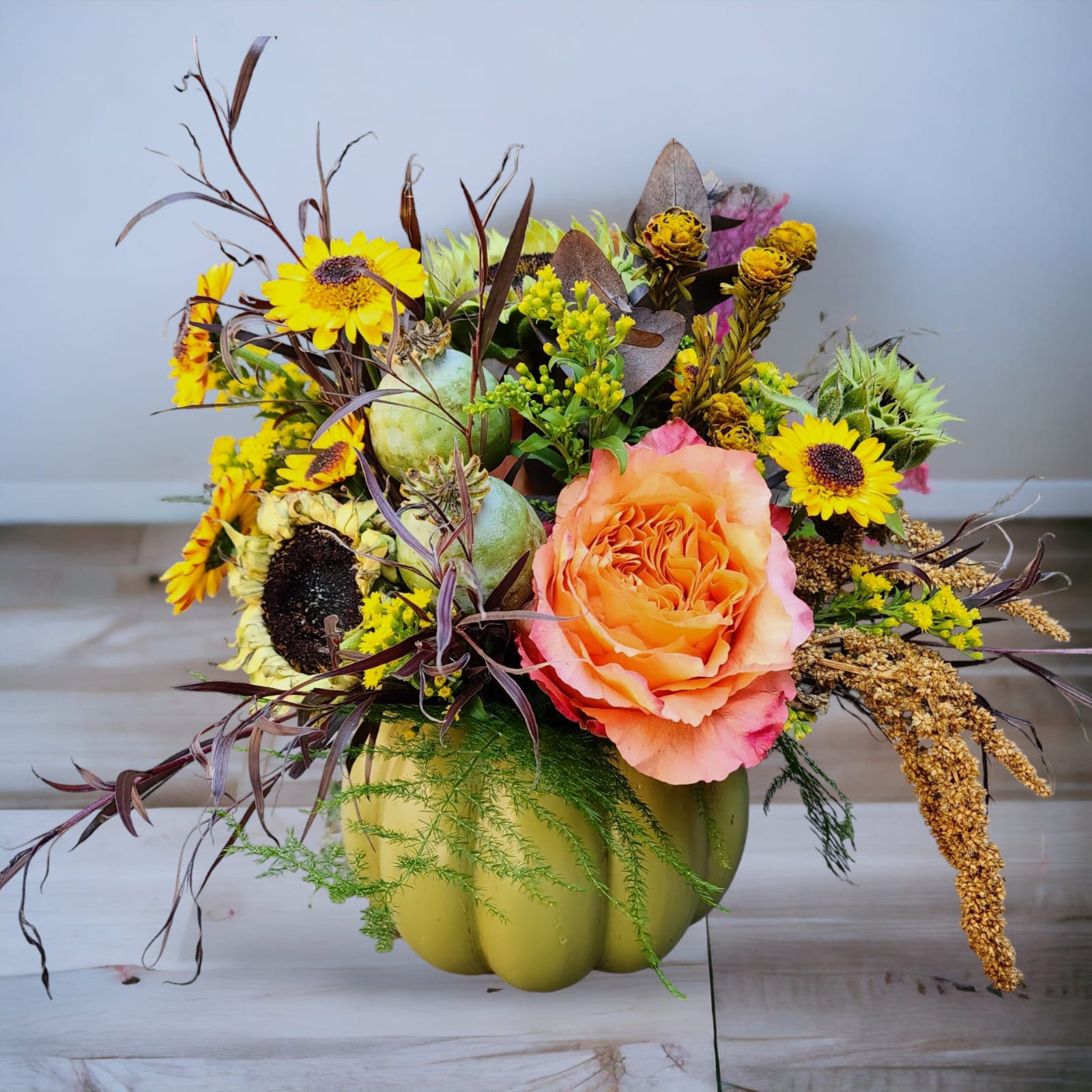 Pumpkin Patch Pumpkin Patch - Introducing our stunning Green Pumpkin Patch Bouquet, a vintage-inspired arrangement that's perfect for those seeking something different, harvest-themed, and rustic. If you're in Olympia, WA, we offer same-day delivery, ensuring you can enjoy these fall favorites without delay. Our Green Pumpkin Patch Bouquet is a unique masterpiece, designed to capture the essence of autumn. It features a delightful combination of vibrant Sunflowers, enchanting Vikings, and rich orange Roses. This carefully crafted ensemble is sure to bring the warmth and charm of the harvest season into your space. The centerpiece of this bouquet is a charming green pumpkin, adding a touch of nostalgia and rustic elegance to your décor. Whether you're looking to adorn your home, surprise a loved one, or enhance a special occasion, our Green Pumpkin Patch Bouquet is the perfect choice. Experience the beauty of fall with a twist, right here in Olympia, WA. Place your order today for same-day delivery and enjoy the magic of this vintage-inspired, harvest-themed floral arrangement.