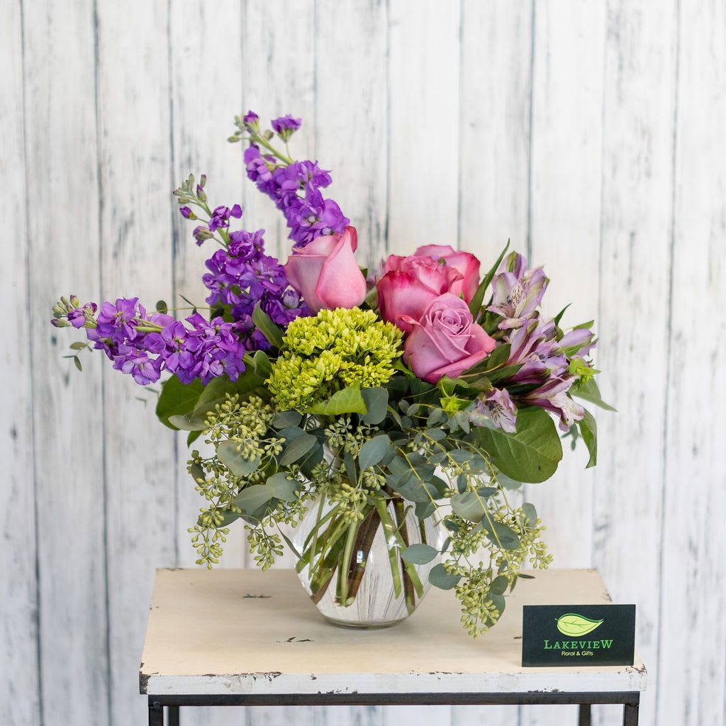 Villa Villa - Lush and lovely like a summer's garden, lavender and purple blooms spill out of a classy clear vase. Approximate Dimensions: 12" H X 15" W