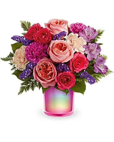 Teleflora's Feeling Magical Bouquet Teleflora's Feeling Magical Bouquet - Turn on the magic with this shimmering, iridescent fuchsia vase, filled with a fabulous rose bouquet. This bouquet features peach roses, dark pink spray roses, purple alstroemeria, hot pink carnations, peach carnations, purple sinuata statice, leatherleaf fern and lemon leaf. Delivered in a Magical Muse Cylinder.
