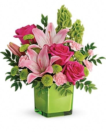 Teleflora's In Love With Lime Bouquet Teleflora's In Love With Lime Bouquet - Lime-a-licious! Fresh shades of green are a great way to contrast pink roses and lilies. Hand-delivered in a lovely leaf green cube, it's a loving gift any day of the week! This refreshing arrangement features dark pink roses, pink asiatic lilies, pink miniature carnations, bells of ireland, green button spray chrysanthemums, and huckleberry. Delivered in a glass cube.Approximately 14" W x 15" H