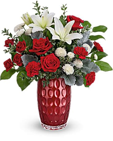 Teleflora's Love In Style Bouquet Teleflora's Love In Style Bouquet - Do Valentine's Day in style with this elegant glass vase, filled with romantic blooms and adorned with a contemporary pattern and shimmering pearlescent finish. This bouquet includes red roses, red spray roses, white asiatic lilies, red carnations, white button spray chrysanthemums, dusty miller, oregonia and lemon leaf. Delivered in a Love Always Vase.