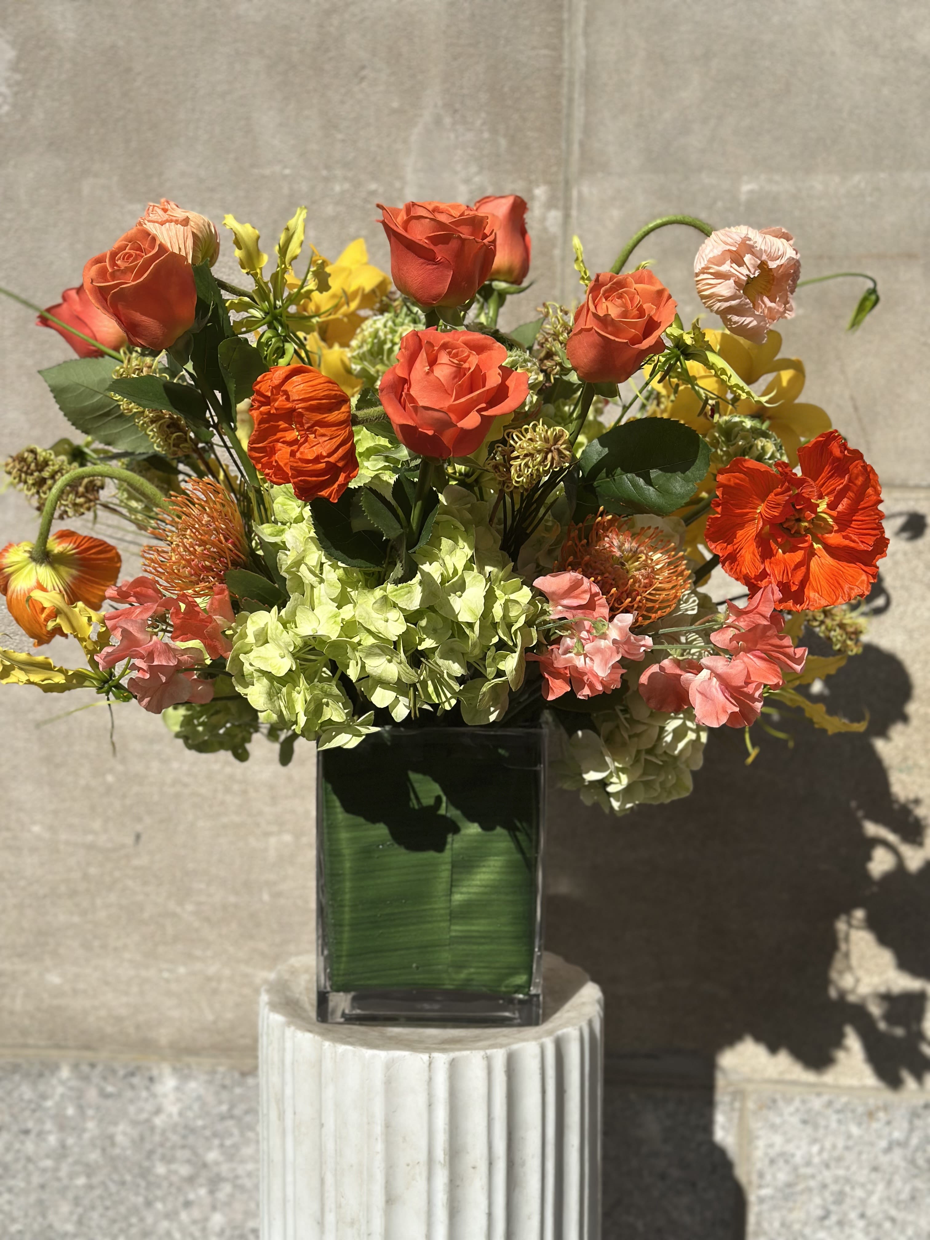 Foraged Flora - Flowers by Philip is absolutely thrilled to introduce Foraged Flora! Get ready to be dazzled by this vibrant floral masterpiece featuring stunning yellow cymbidium orchids and the enchanting elephant poppies, all lovingly harvested in Italy. These beautiful blooms are artfully surrounded by elegant roses and refreshing lime green hydrangeas, perfectly paired with exquisite pom pom ranunculus sourced from southern Italy, alongside the striking Japanese gloriosa. This composition is a celebration of nature’s beauty that you won’t want to miss!