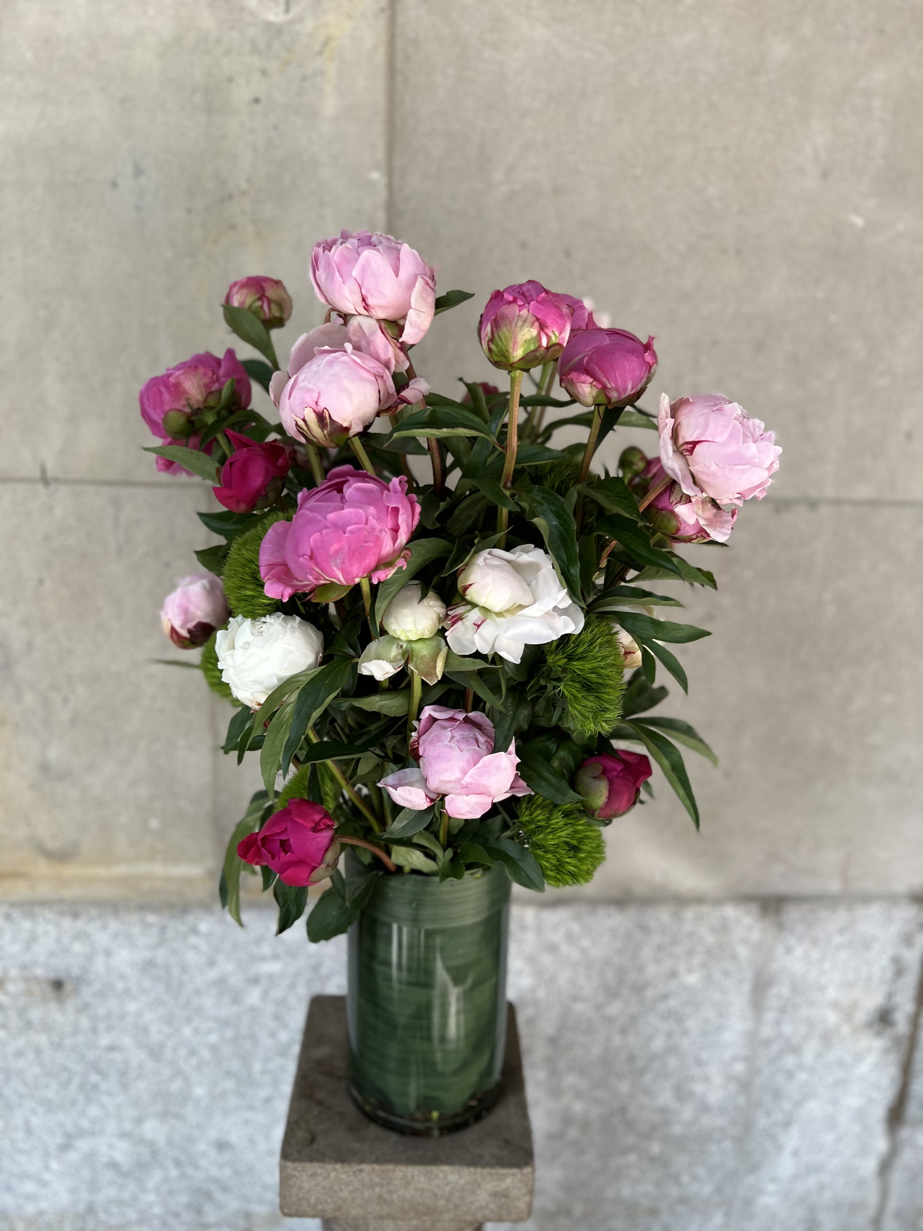 SIFRINA MADNESS - Peonies and green trick sweet William  arranged in a glass cylinder. 