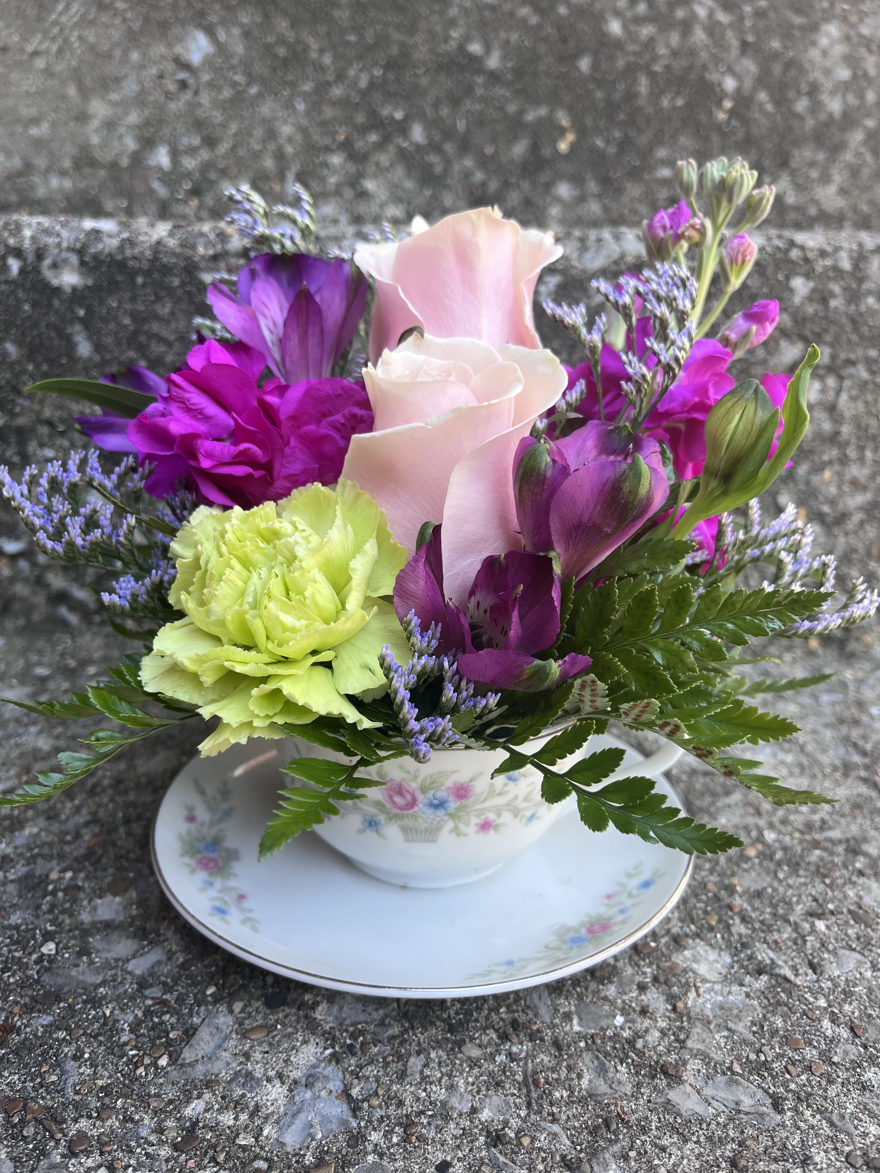 Passion Paradise Tea Cup  - This arrangement has roses, stock, carnations, alstroemeria, misty and greenery. 