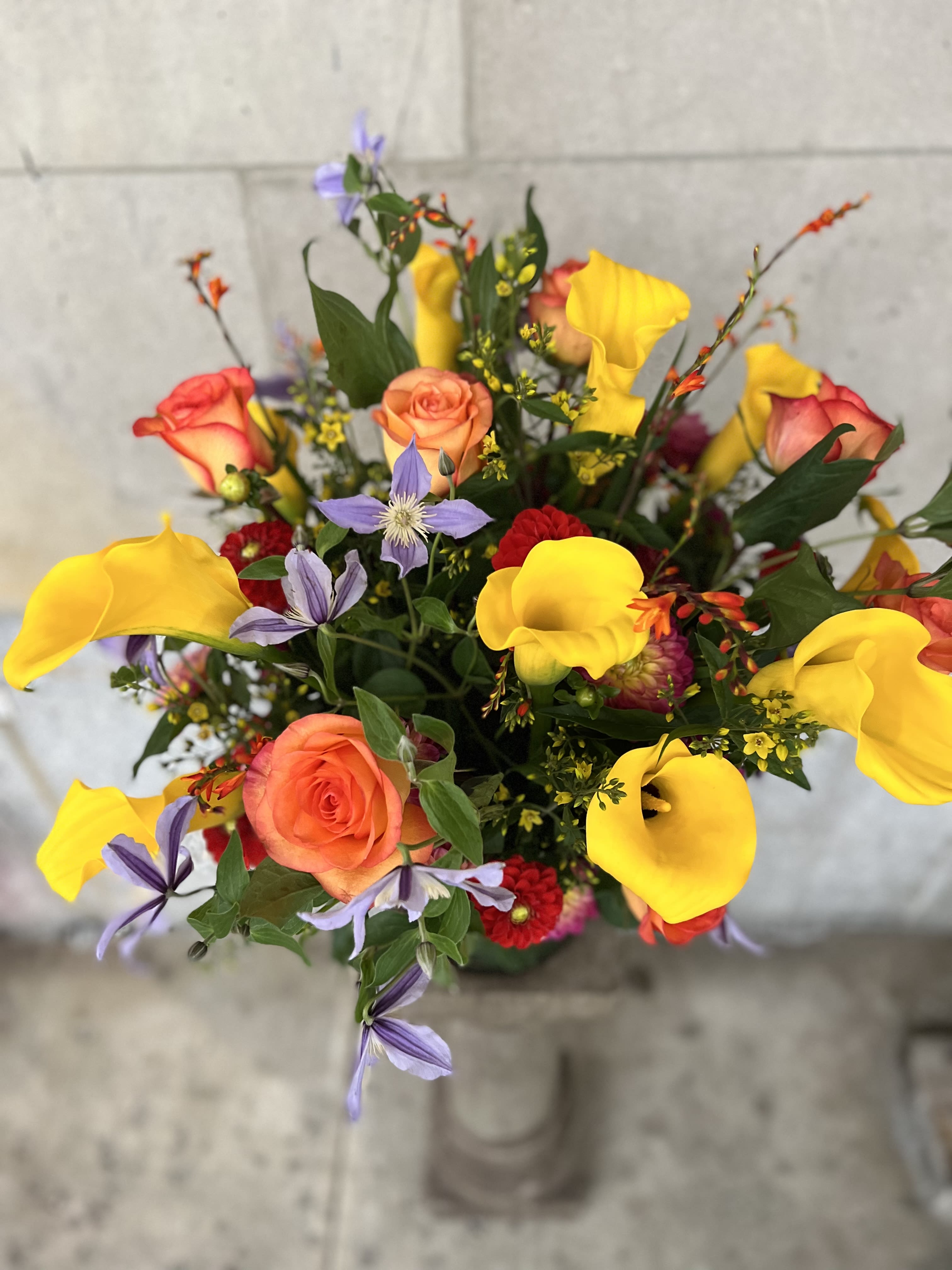 ALWAYS ON MY MIND - Medium to tall composition assortment of yellow captain calla lily's, yellow lysimachia, clematis star river , free spirit roses, surrounded by lots of grown field dahlias. 