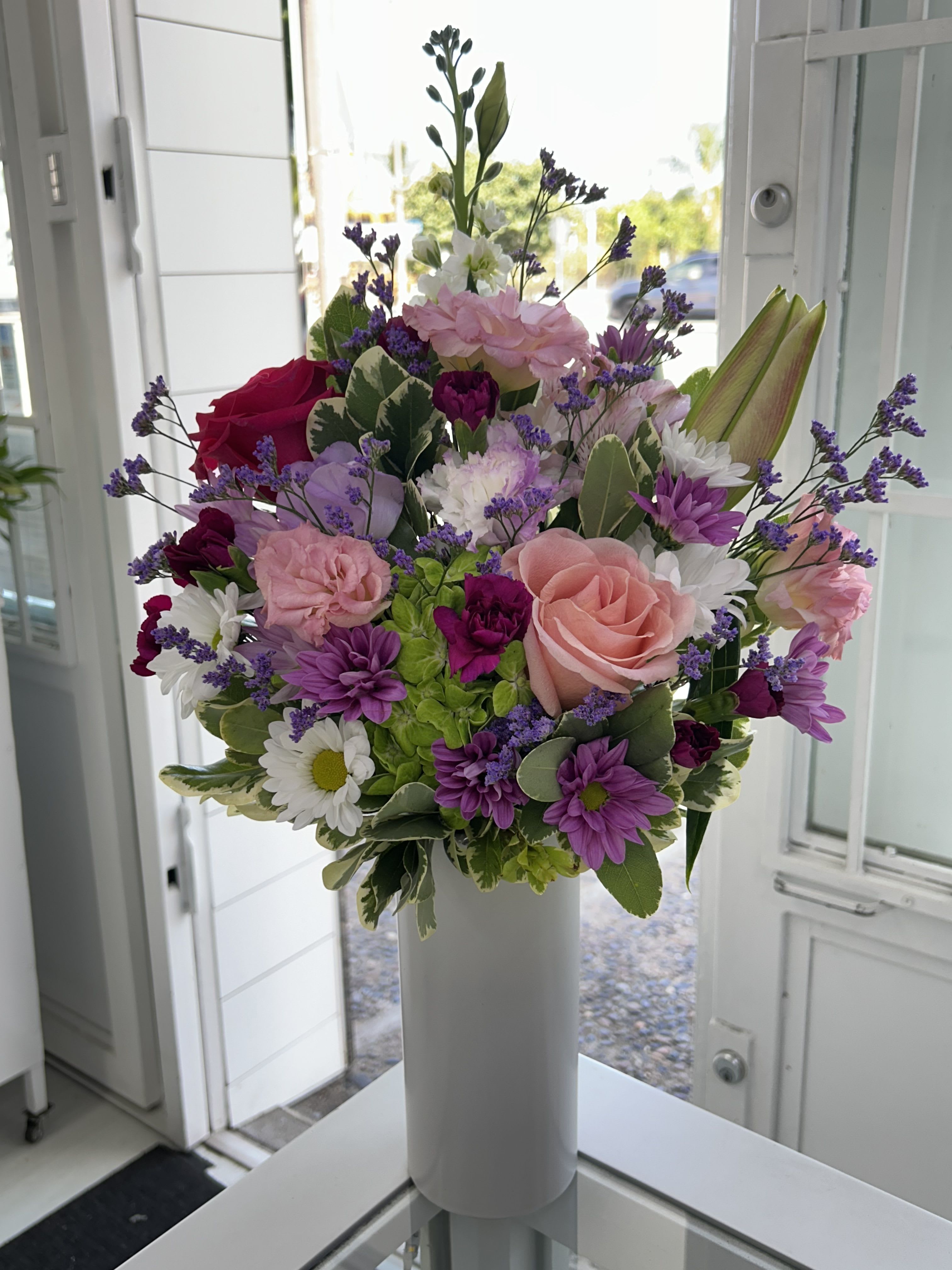 Blush And Bloom - A joyful mix of blush roses, daisies, and vibrant blooms - perfect for adding beauty and cheer to any occasion! (If some flowers and/or the vase are not available there will be minor substitutions.)