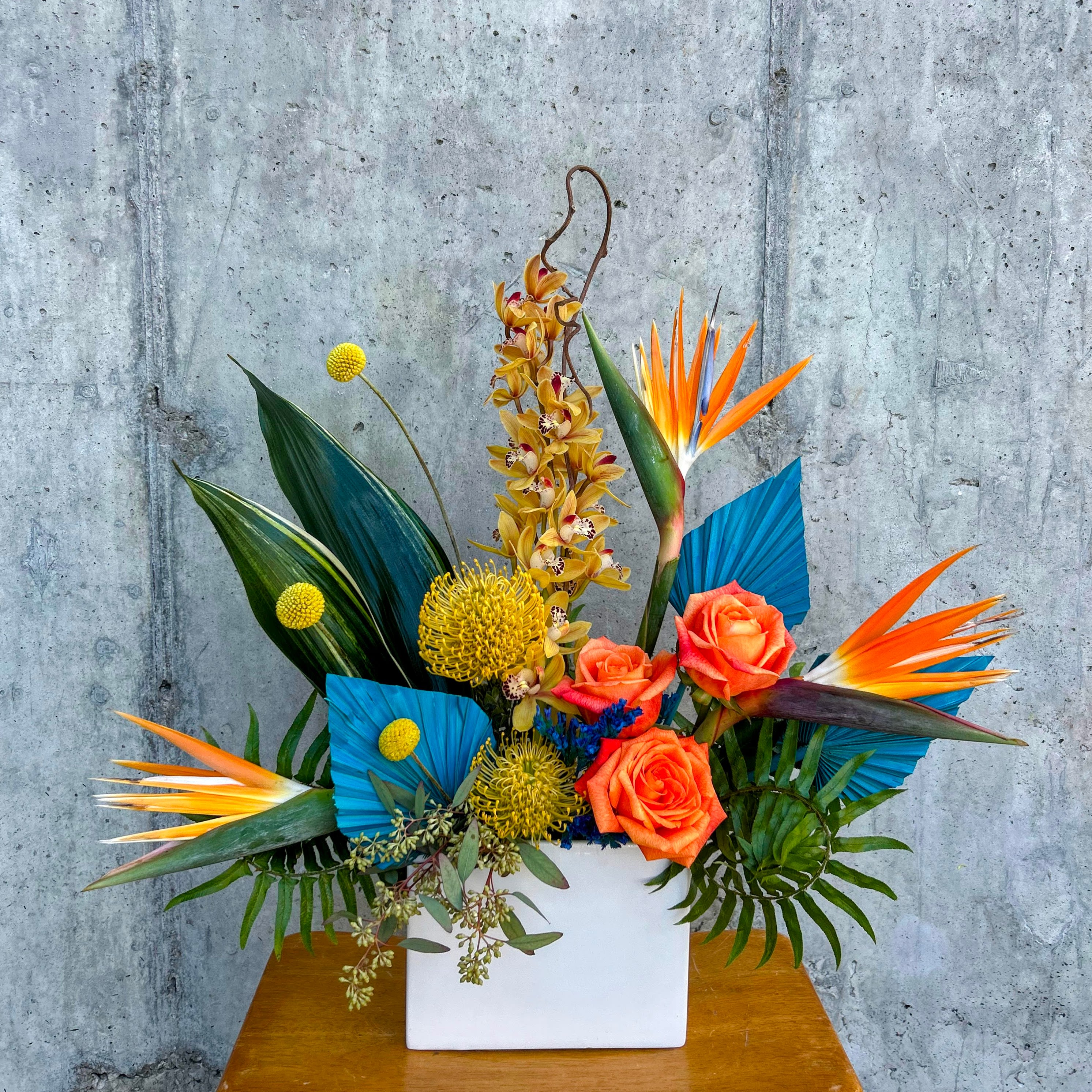 Playful Paradise - This whimsical and jubilant tropical arrangement is perfect for any bird of paradise lover. Flourishing with vibrant hues and exotic textures in a highly stylized design. Elevate your space with this captivating blend of artistry and nature, curated just for you.