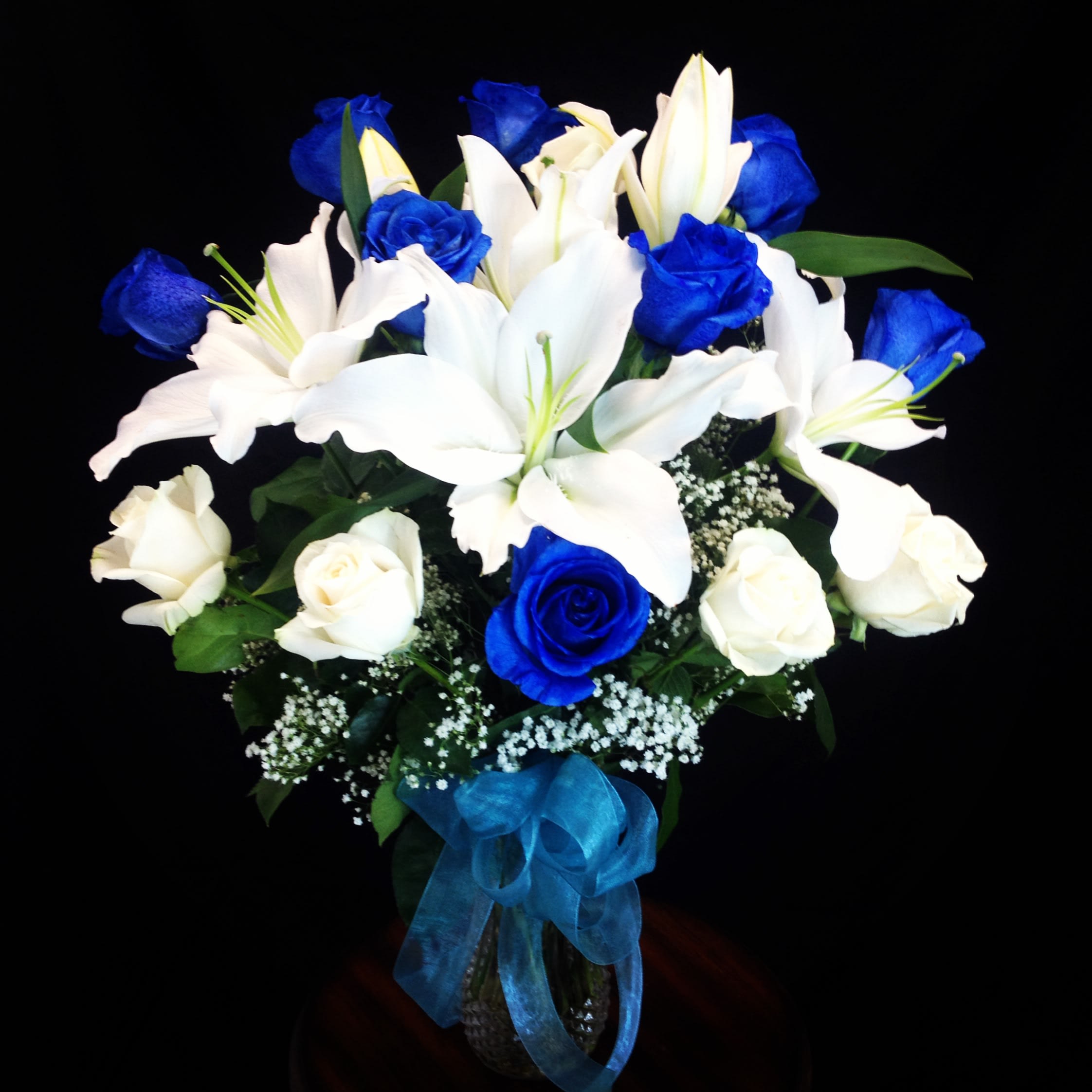 blue and white majestic - A beautiful arrangement with blue roses and white with white lilies 