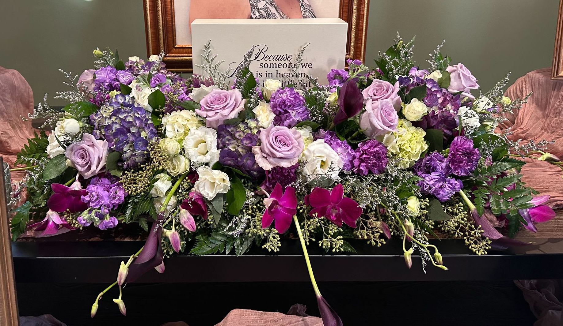 Memorial Spray MS-17 Memorial Spray MS-17 - A lush and graceful tribute, this arrangement features a soothing palette of purples, lavenders, and soft cream tones. Designed to surround an urn or memorial keepsake (urn not included), it includes hydrangea, roses, orchids, carnations, lisianthus, and calla lilies, accented with silver foliage and seasonal greenery. Rich in color and sentiment, this design brings a touch of peaceful beauty to the service while honoring a life remembered with love and tenderness.