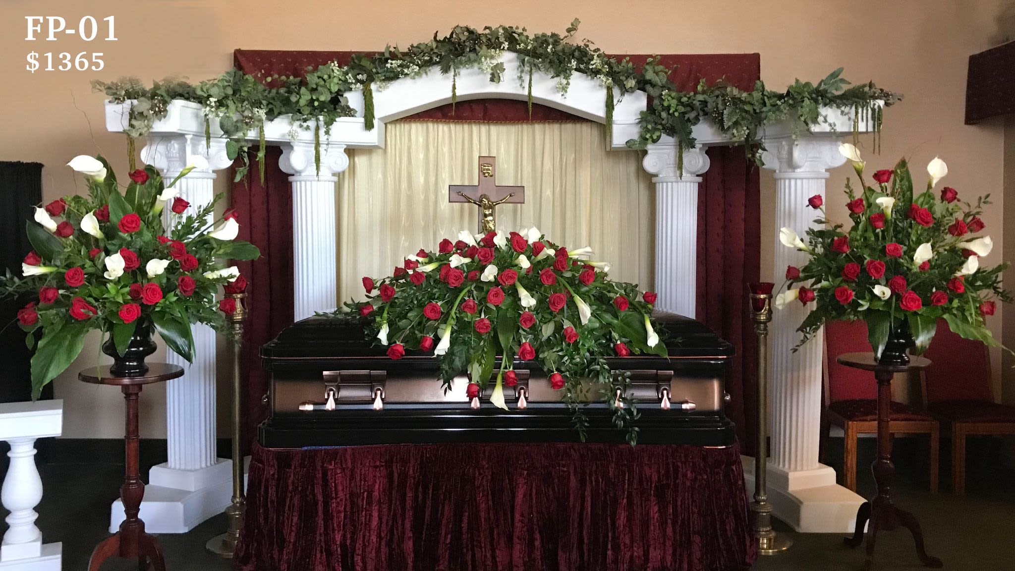 Funeral Package FP-01 Funeral Package FP-01 - This striking funeral presentation features a trio of coordinated arrangements: a full casket spray flanked by two matching ceremony arrangements, each overflowing with premium red roses and graceful white calla lilies. Symbolizing deep love and peace, this timeless tribute is perfect for honoring a spouse, parent, or close family member. Ideal for traditional funeral services in Goodyear, Litchfield Park, Verrado, and surrounding West Valley areas. Includes matching pedestal stands and setup. For custom flower choices or color palette, please contact us directly.
