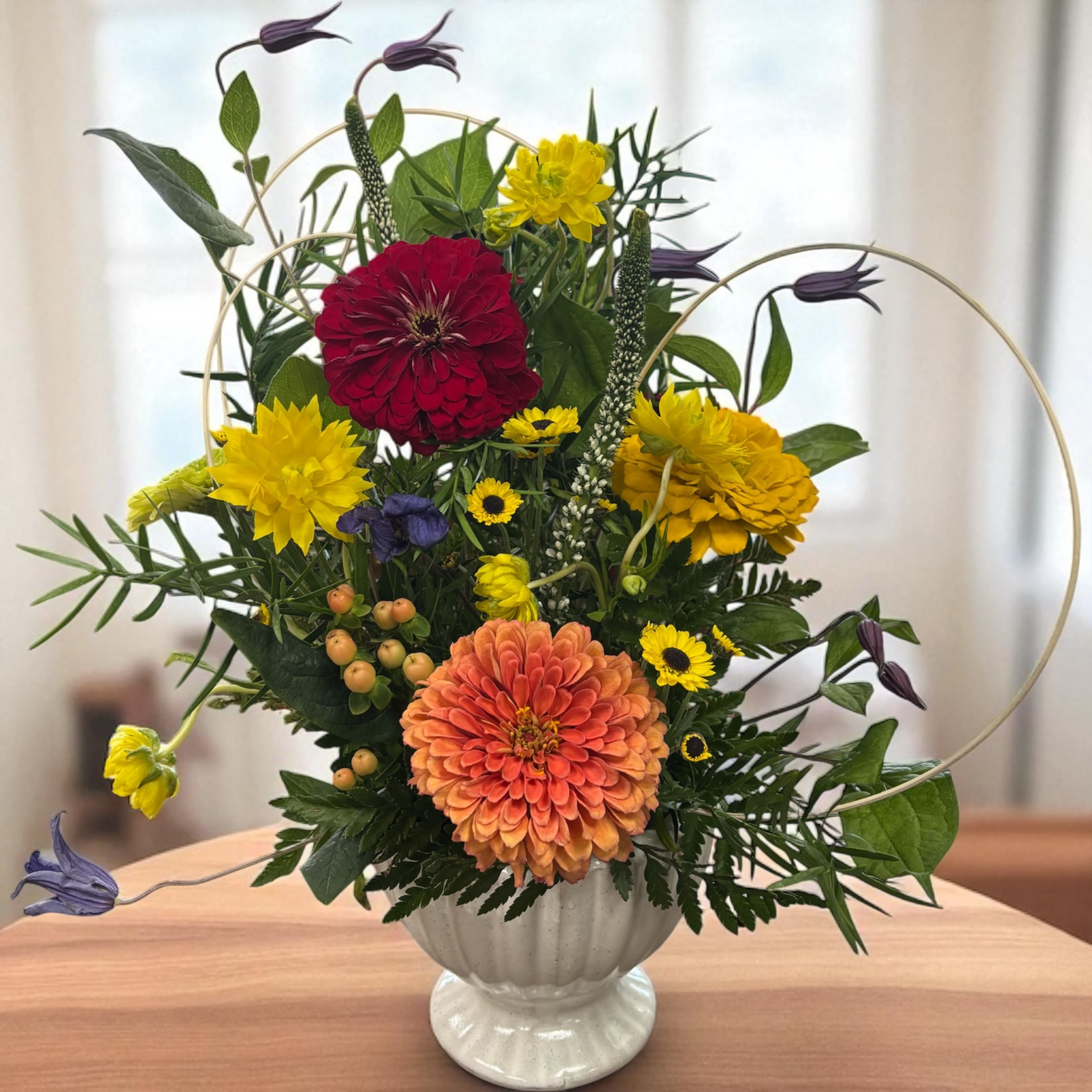 Picture perfect - Like something from a painting by the old masters this beautiful design is filled with seasonal flowers that are both solid and airy. The lovely ceramic container will be kept and used for years to come.