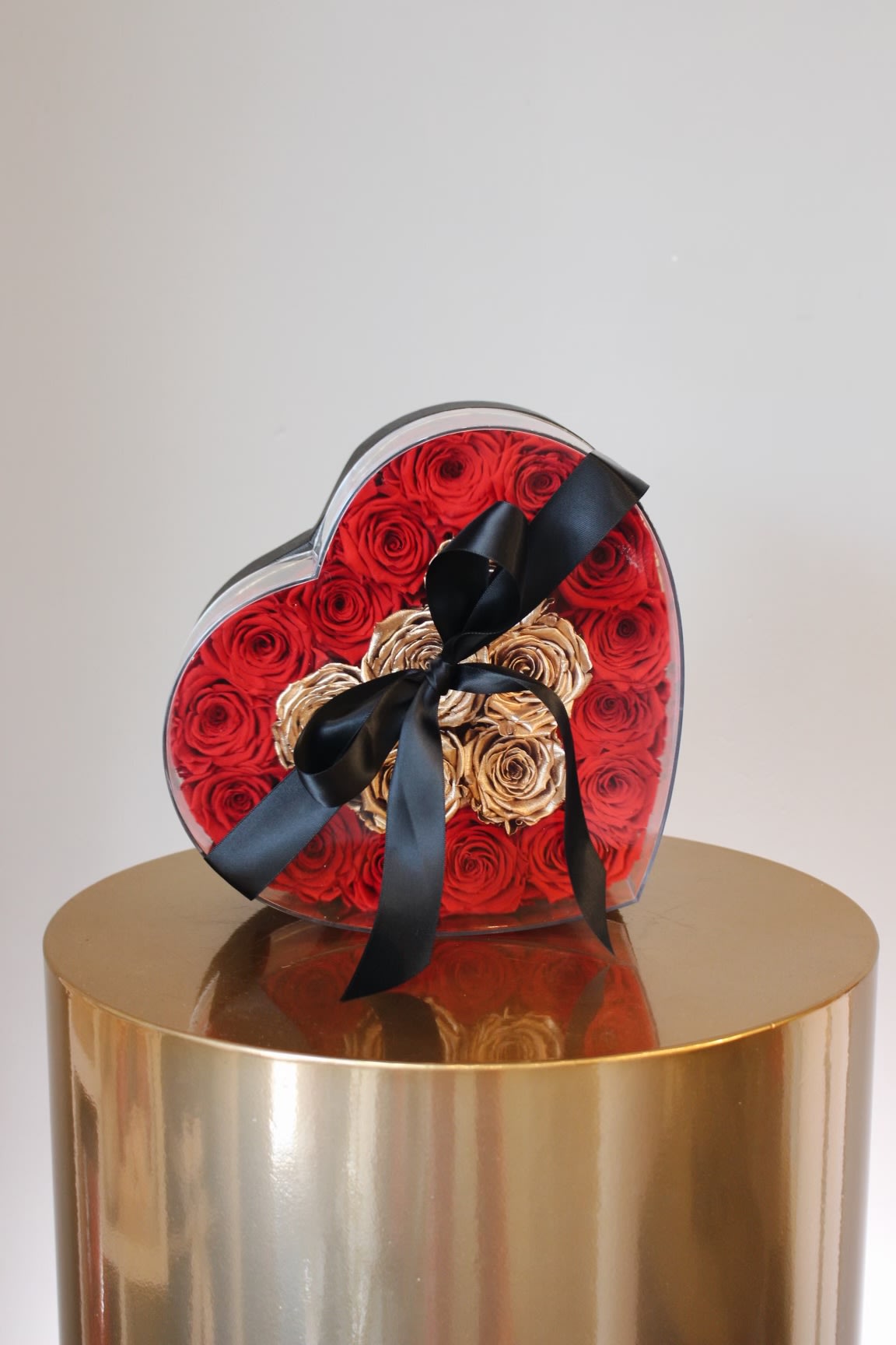 Bellissimo ™ - A romantic heart-shaped case filled with preserved red roses and accented with radiant gold roses at the center. A show-stopping display of love that lasts 3 or more years.