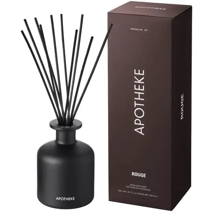 Apotheke Charcoal Rouge Reed Diffuser - The Fragrance Charcoal Rouge combines velvety damask rose, crushed geranium leaf bathed in spicy elemi resin with hints of lemon and infused with the smoky and earthy essence of burning birch to create an intoxicating and romantic fragrance.  The Product Made from a premium alcohol-free formula blended with essential and perfume-grade fragrance oils, this reed diffuser is formulated to provide a continuous and exceptional scent experience for approximately 3 to 4 months. Includes 10 black all-natural rattan diffuser reed sticks.  The Vessel The black glass base with its luxe matte finish enhances any space with a modern and timeless design. When empty, help reduce waste by purchasing a Charcoal Rouge Reed Diffuser Refill to replenish and reuse your existing Charcoal Rouge glass base.  Made in United States